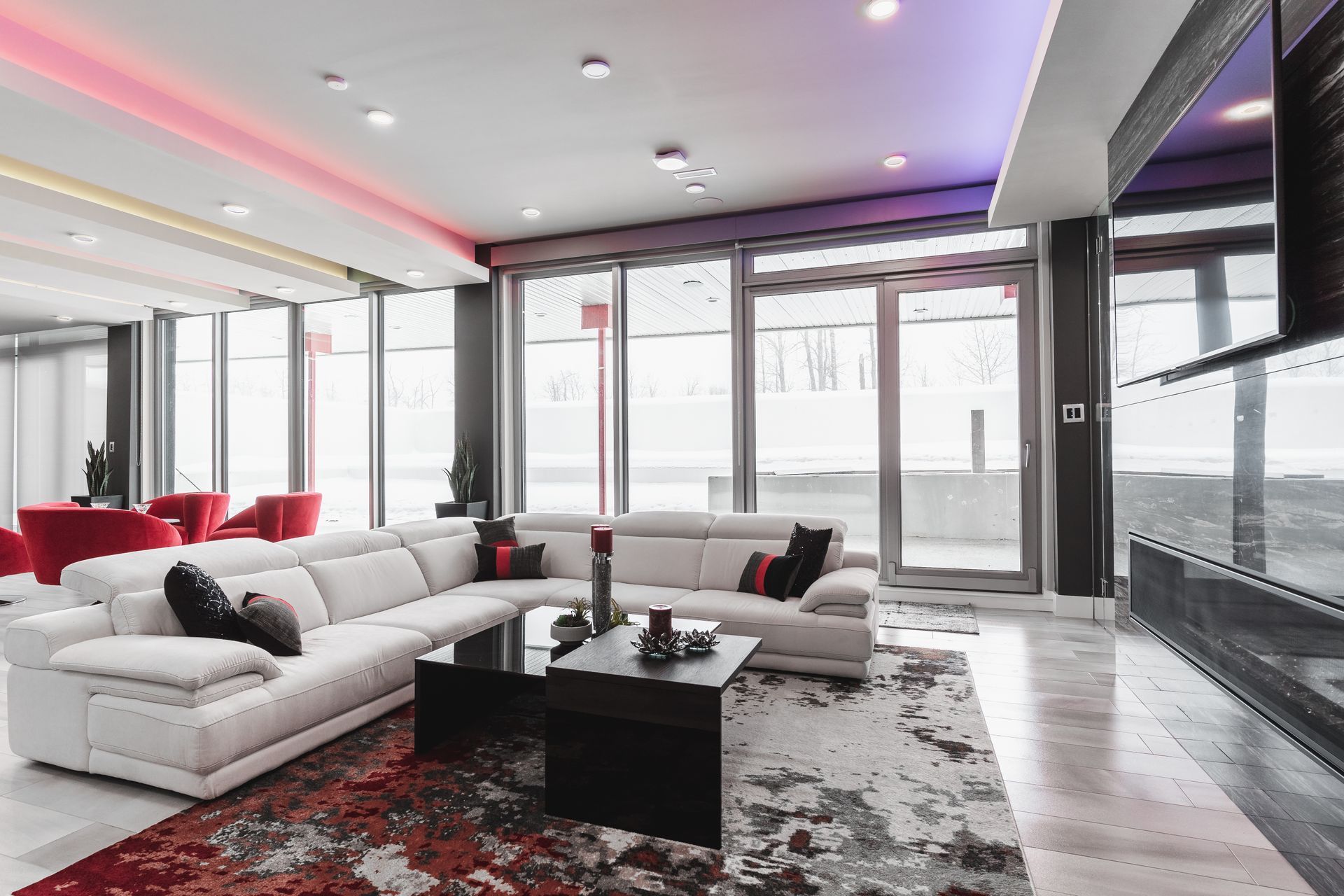 A living room with a large sectional couch and a coffee table.