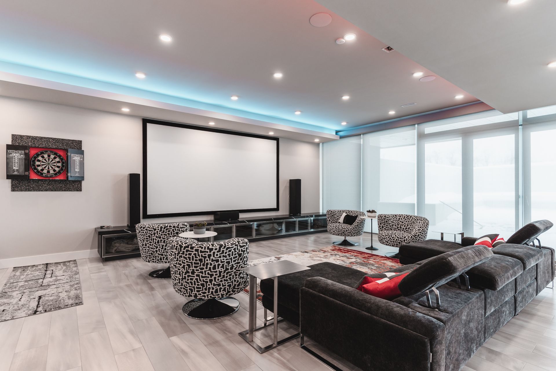 A living room filled with furniture and a projector screen.