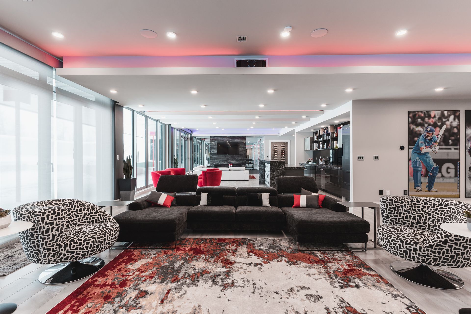 A living room with a couch , chairs , and a rug.
