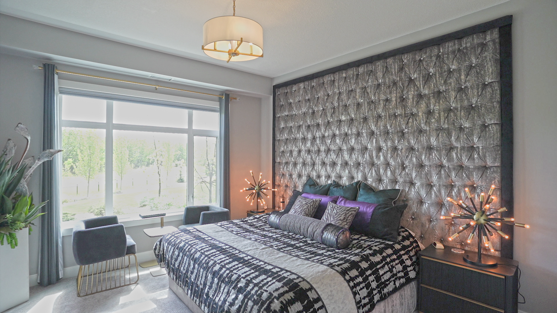 A bedroom with a large bed and a large window.