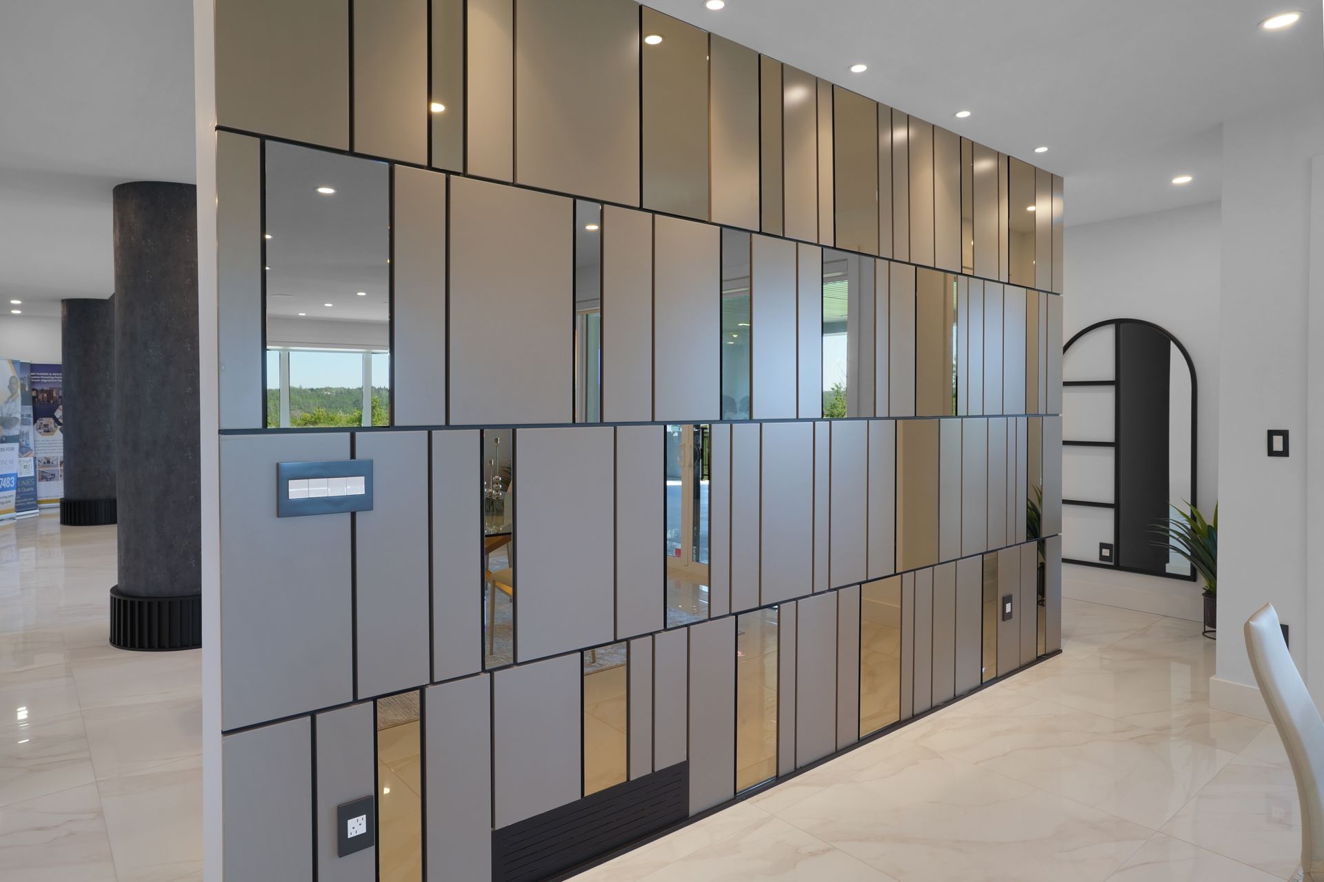A wall with a lot of mirrors on it in a room.