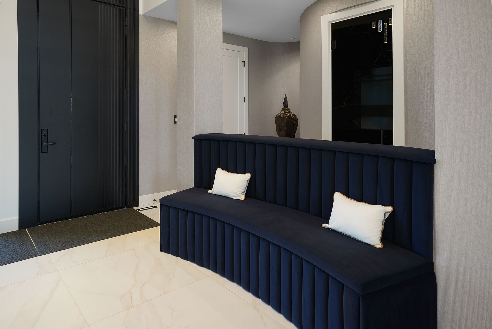 There is a curved couch in the middle of the room.