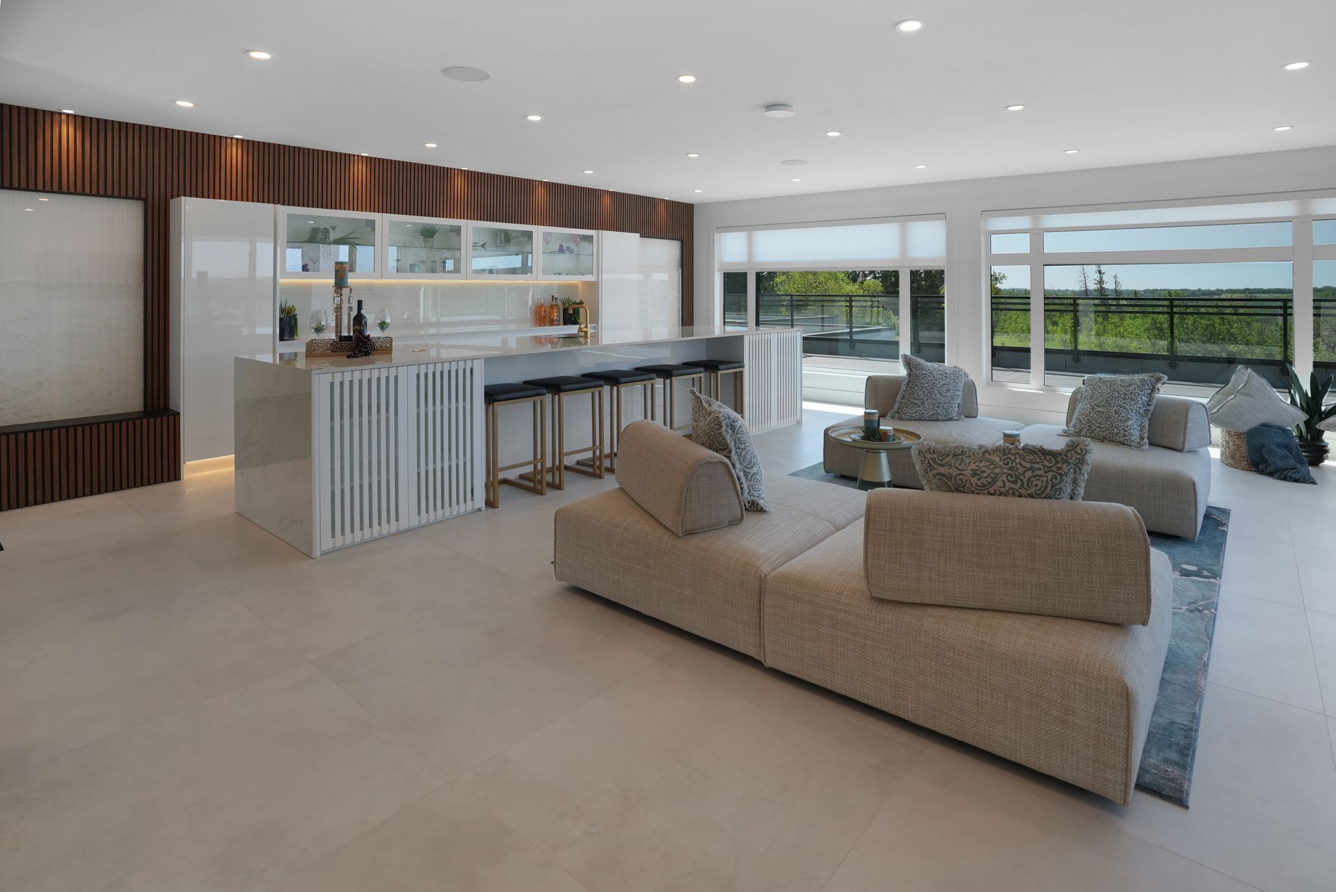 A living room with a couch and chairs and a kitchen