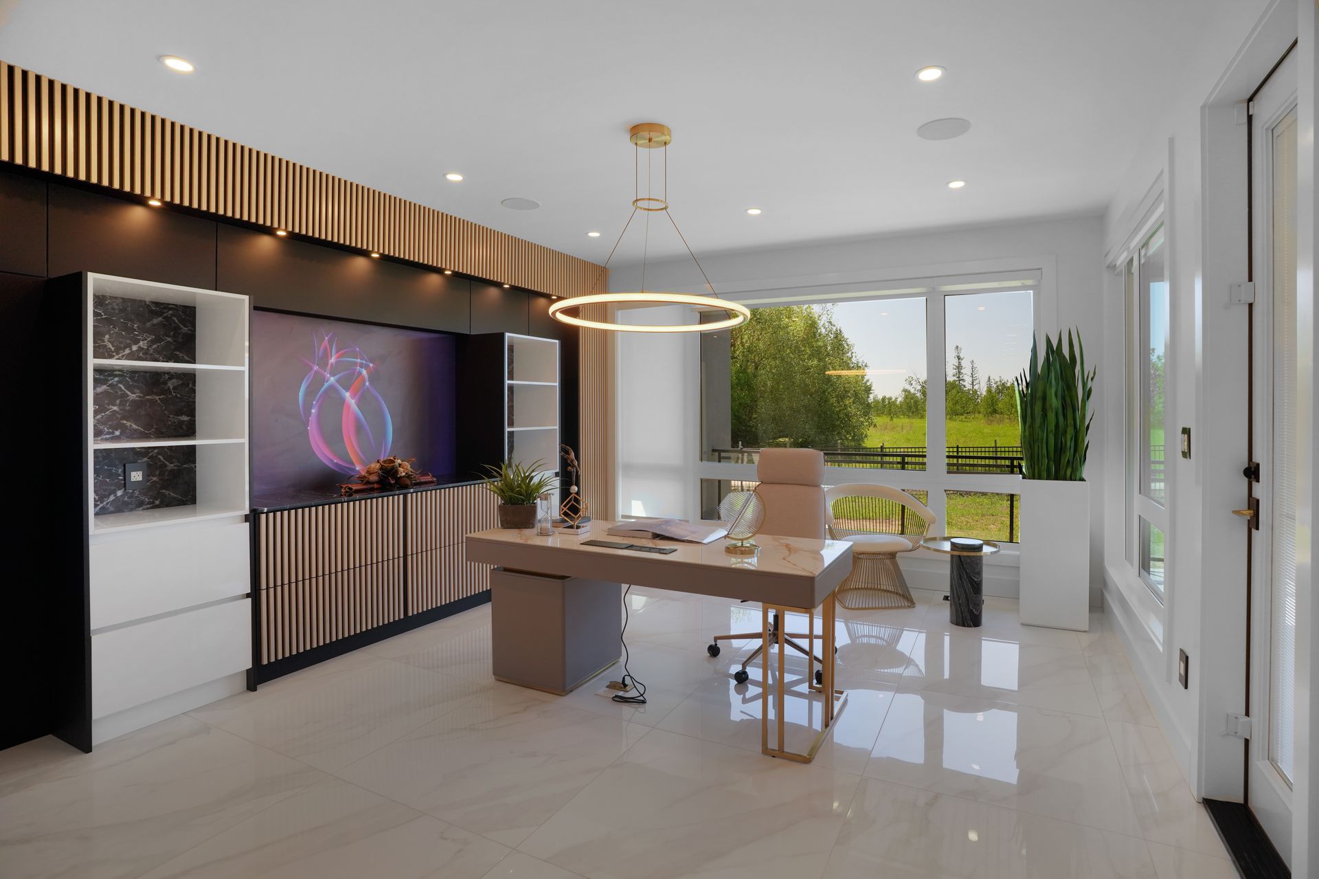 A modern office with a desk and chairs and a large window.