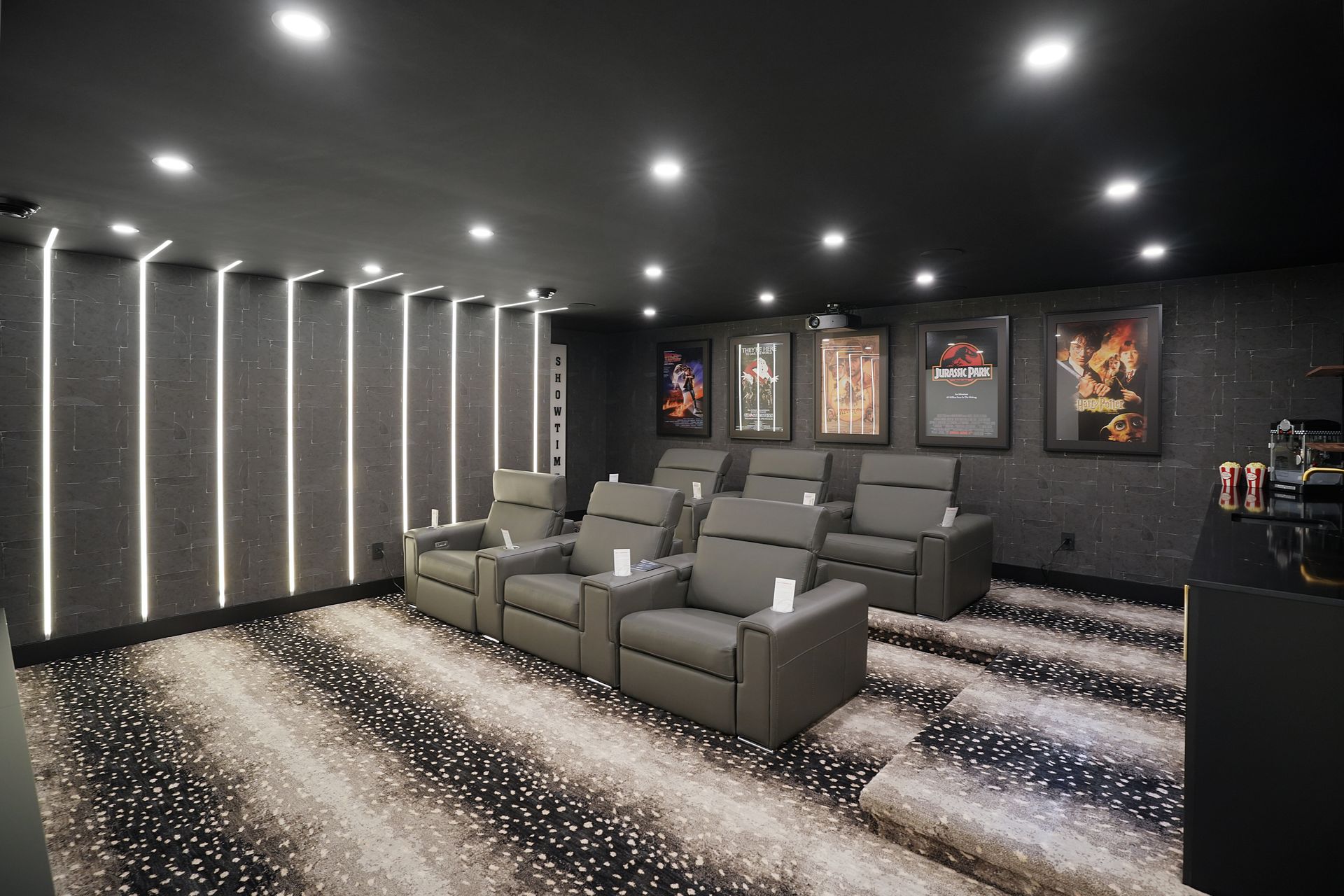 An artist 's impression of a home theater with chairs and a rug.