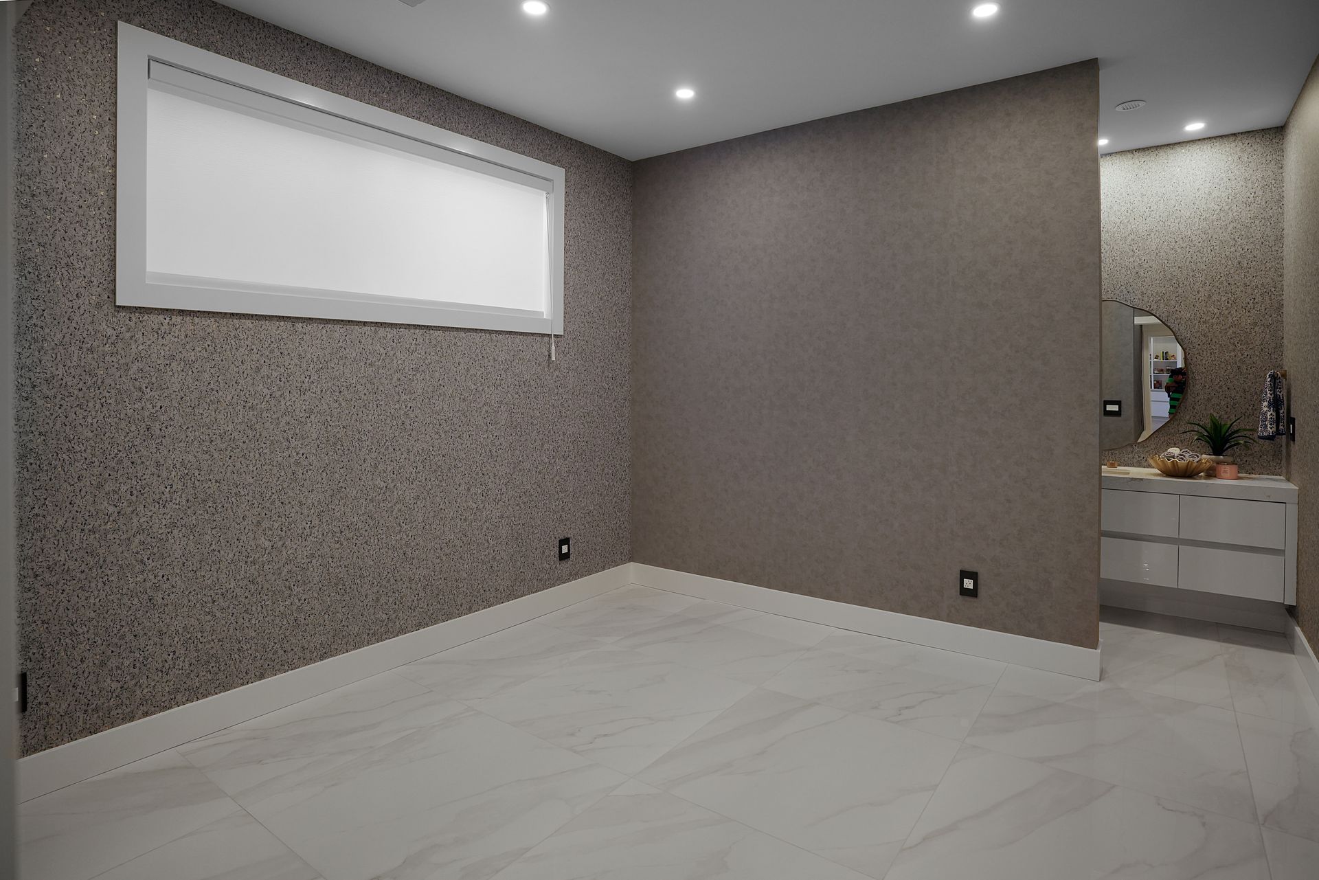 A room with a window and a sink in it.