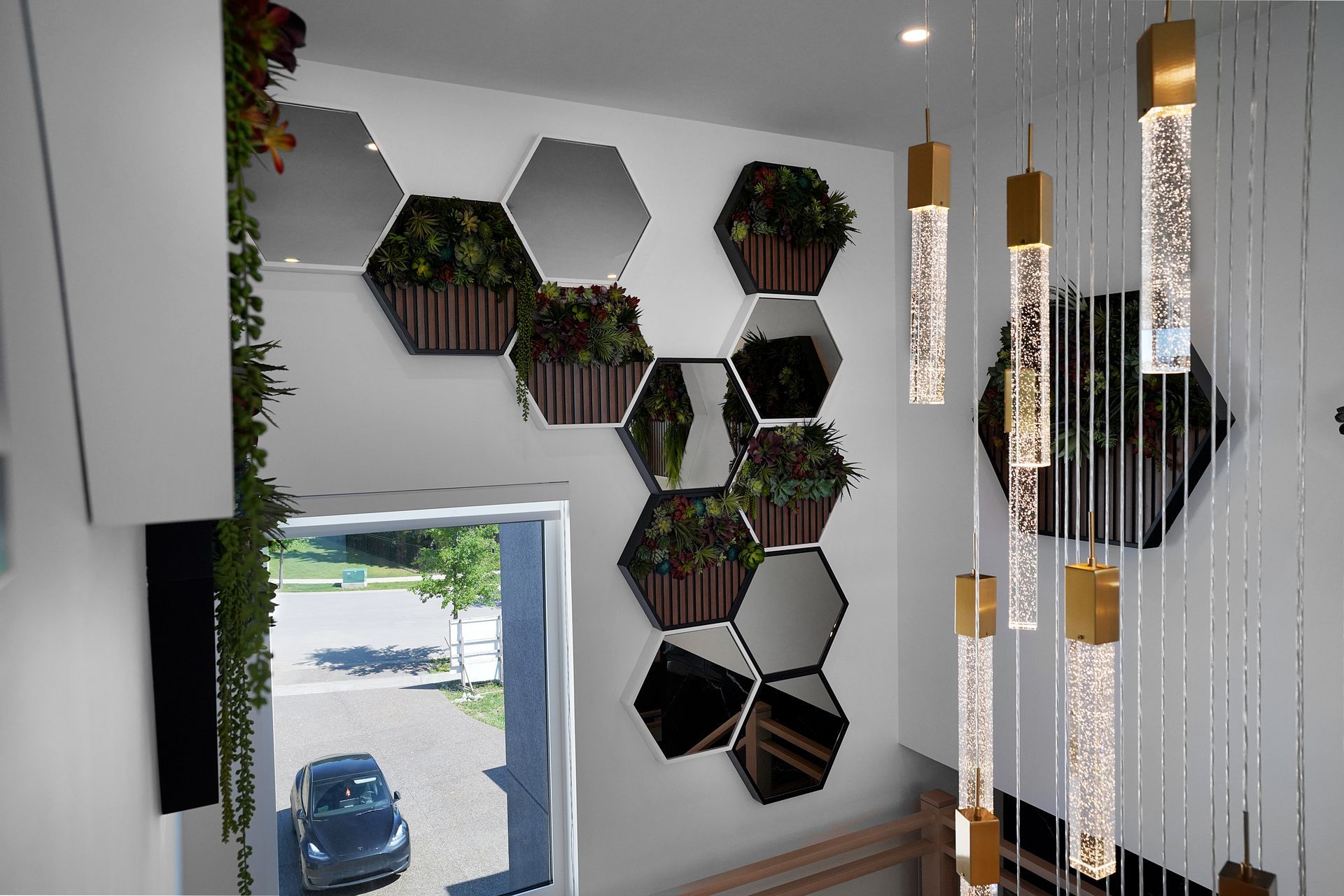 A room with a lot of mirrors and plants on the wall