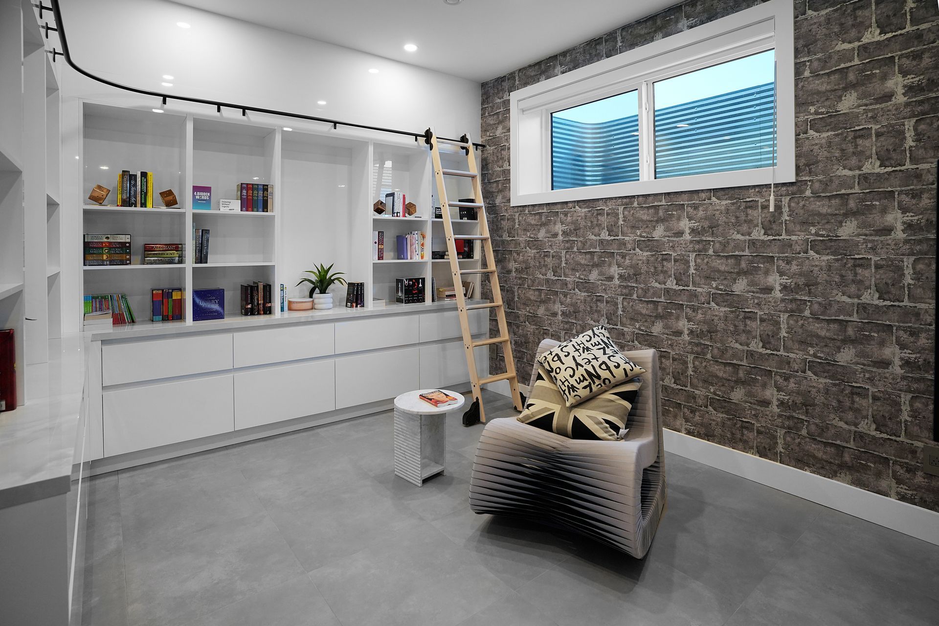 A living room with a chair and a ladder.