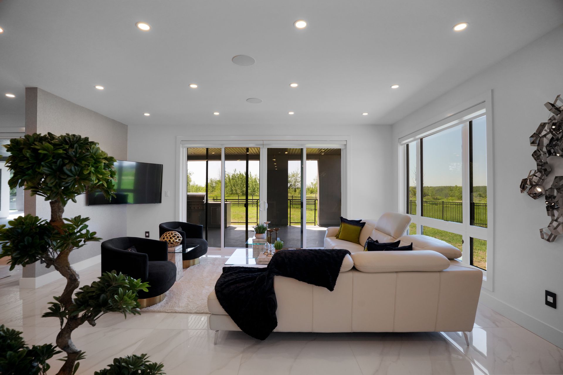 A living room with a couch , chairs , and sliding glass doors.