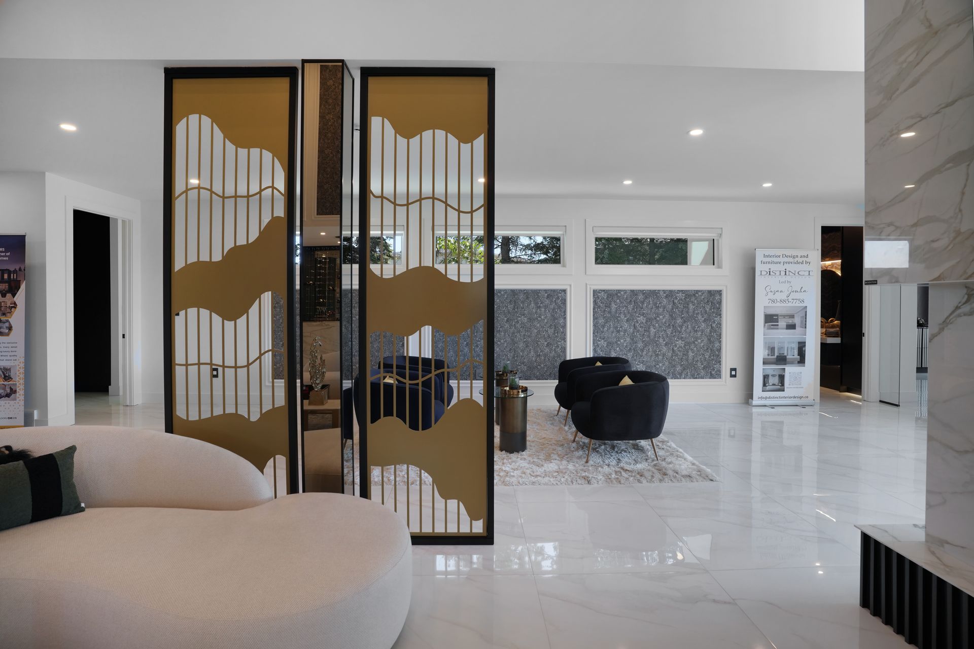 A living room with a couch and chairs and a room divider.