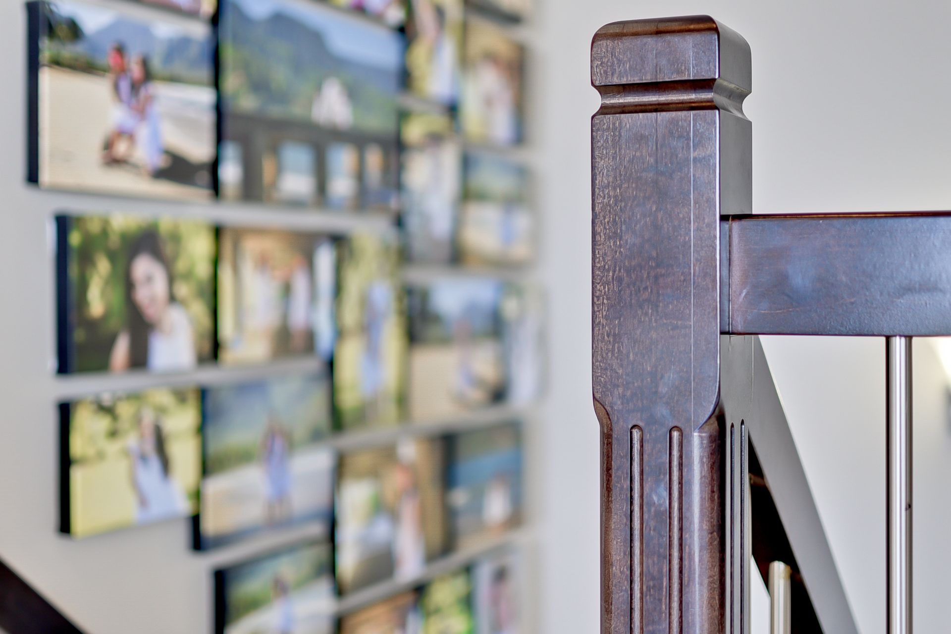 A staircase with a collage of pictures on the wall behind it.