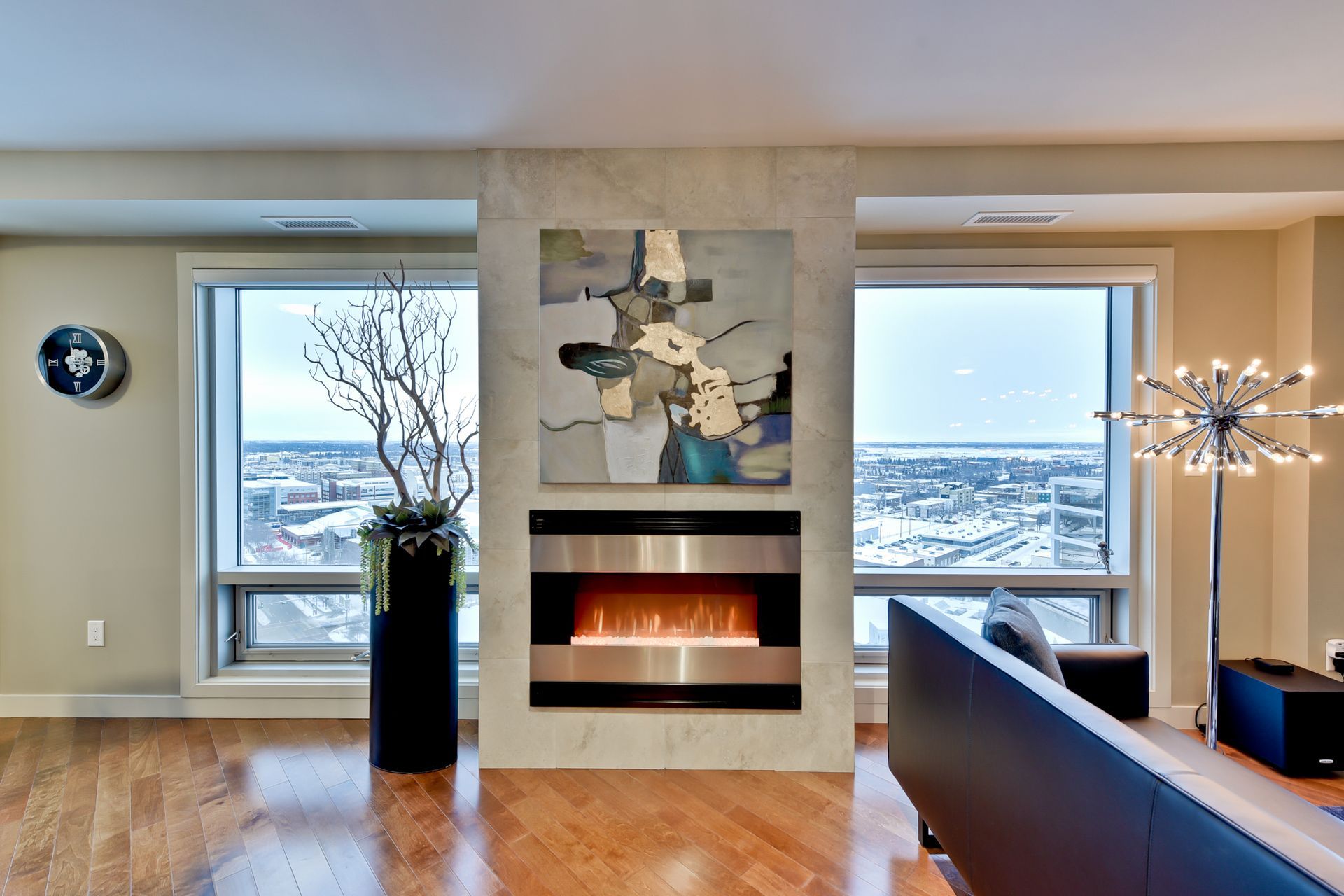 A living room with a fireplace and a painting on the wall
