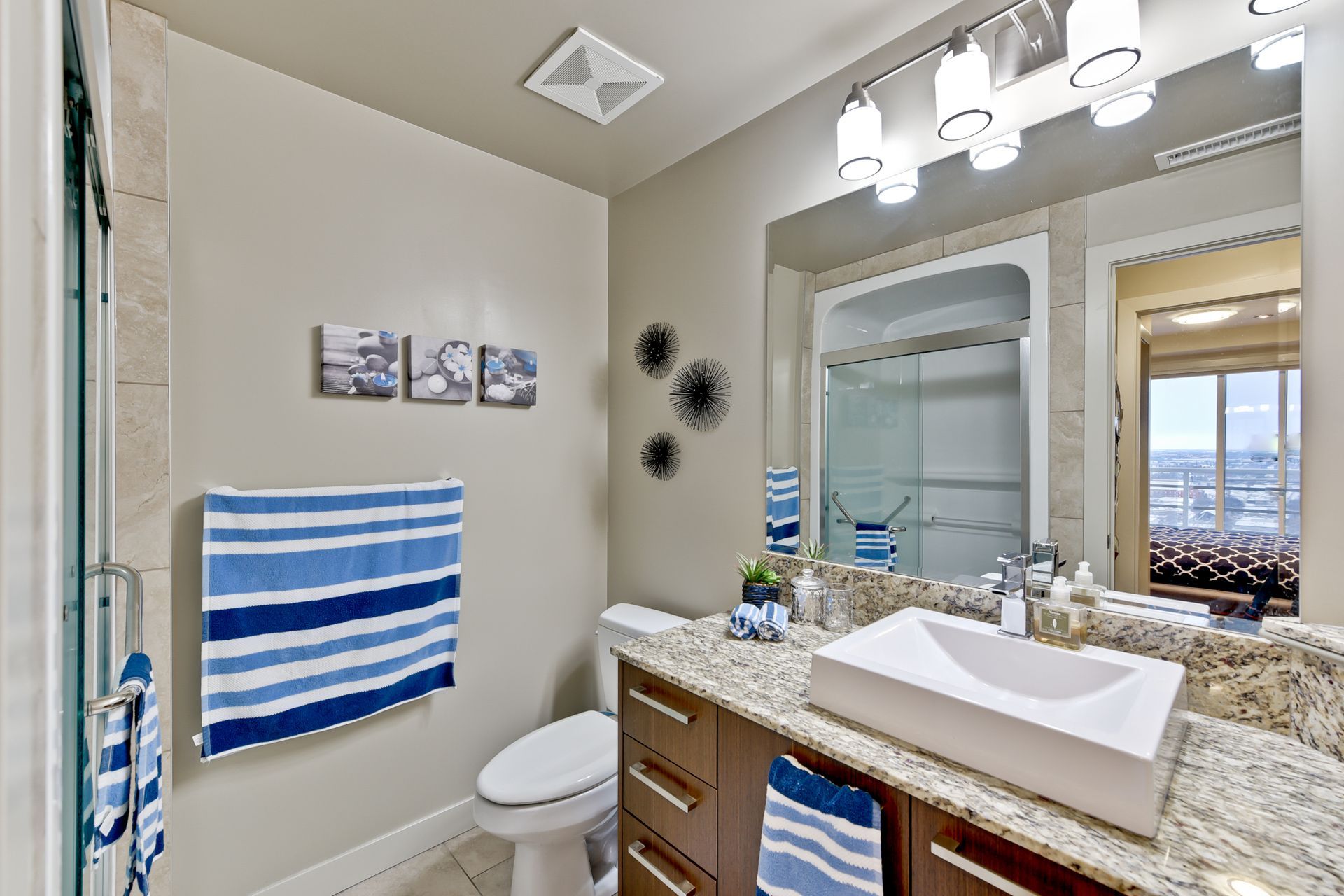 A bathroom with a sink , toilet , and mirror.