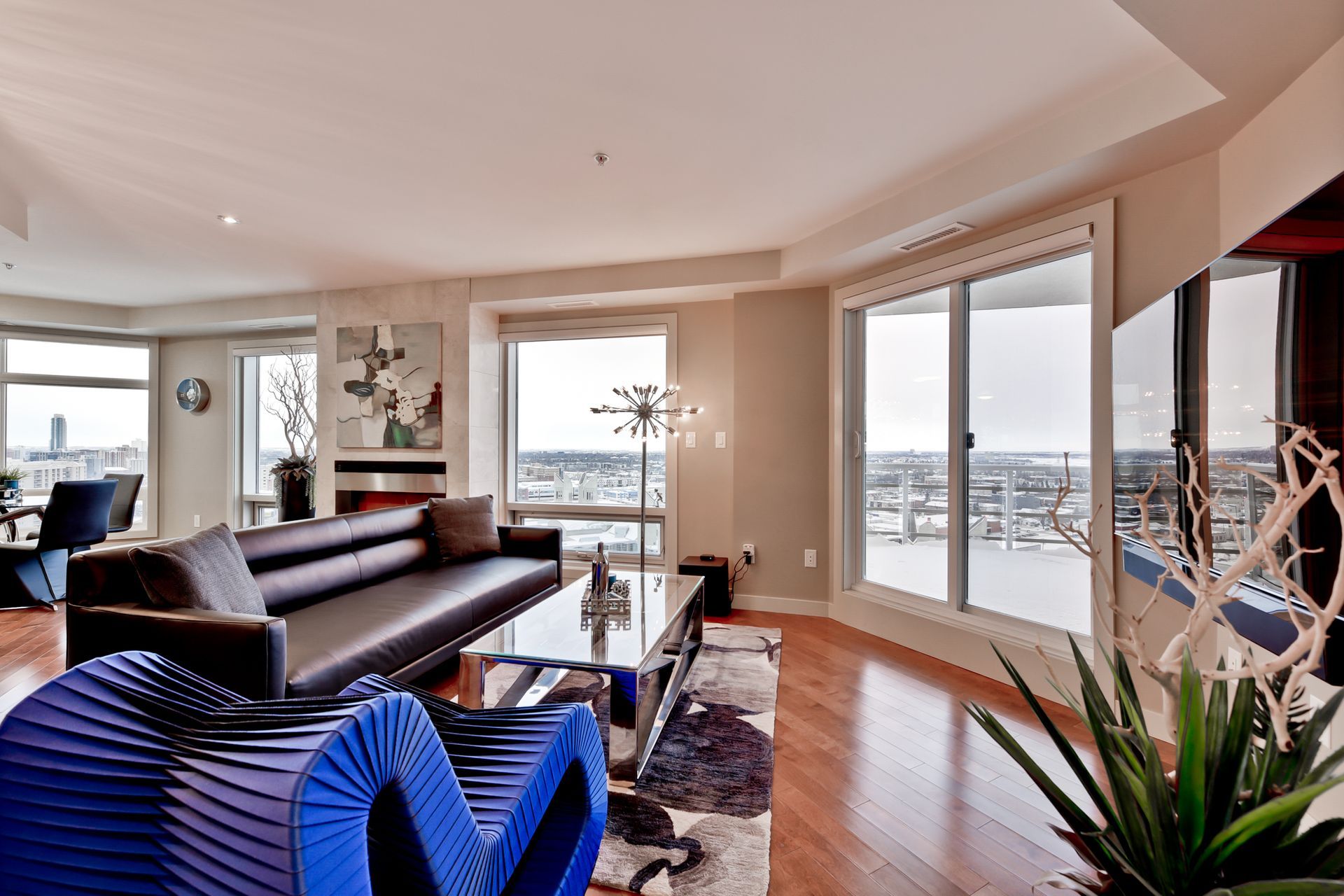 A living room with a lot of windows and a couch