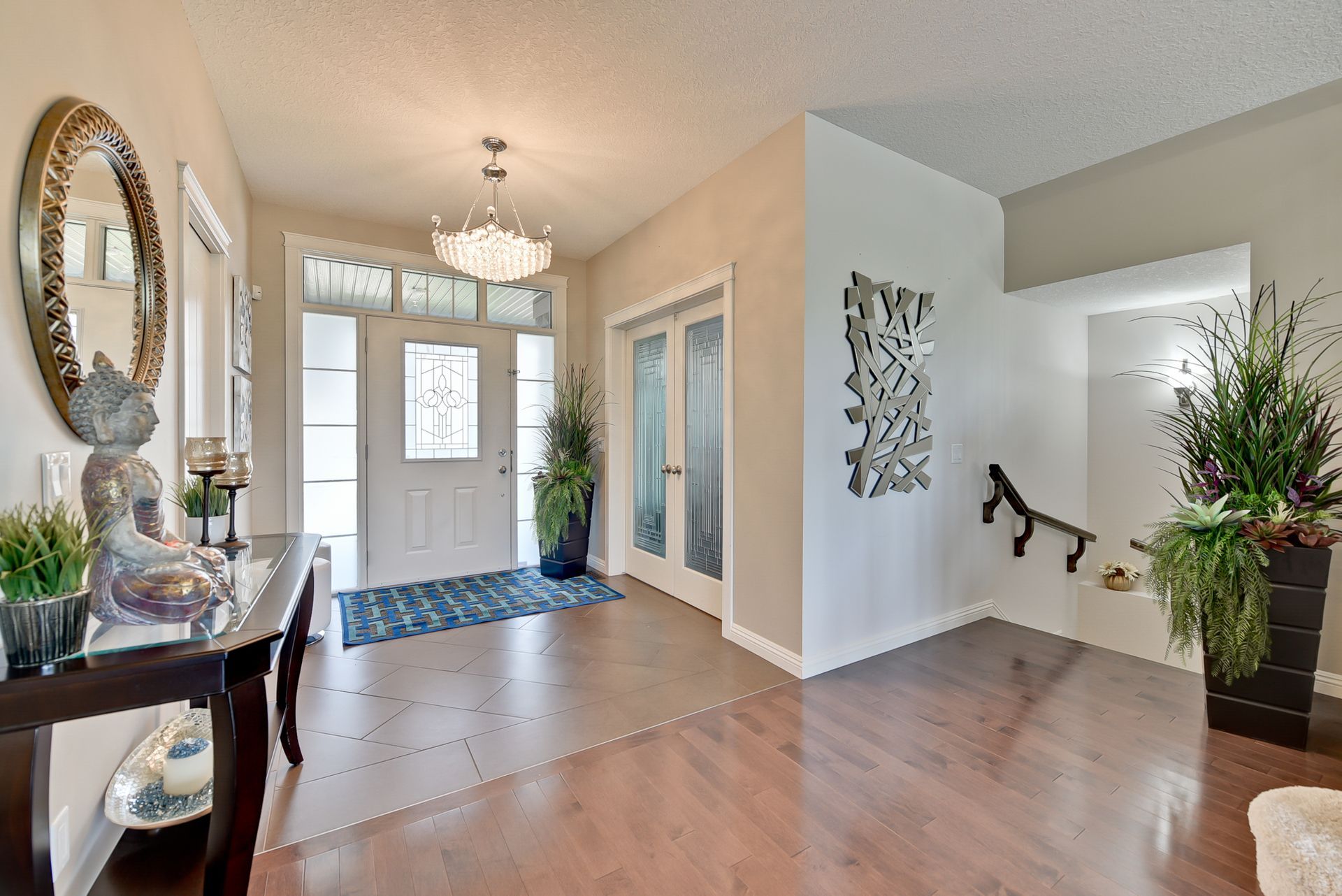 A hallway in a house with a table and a mirror.