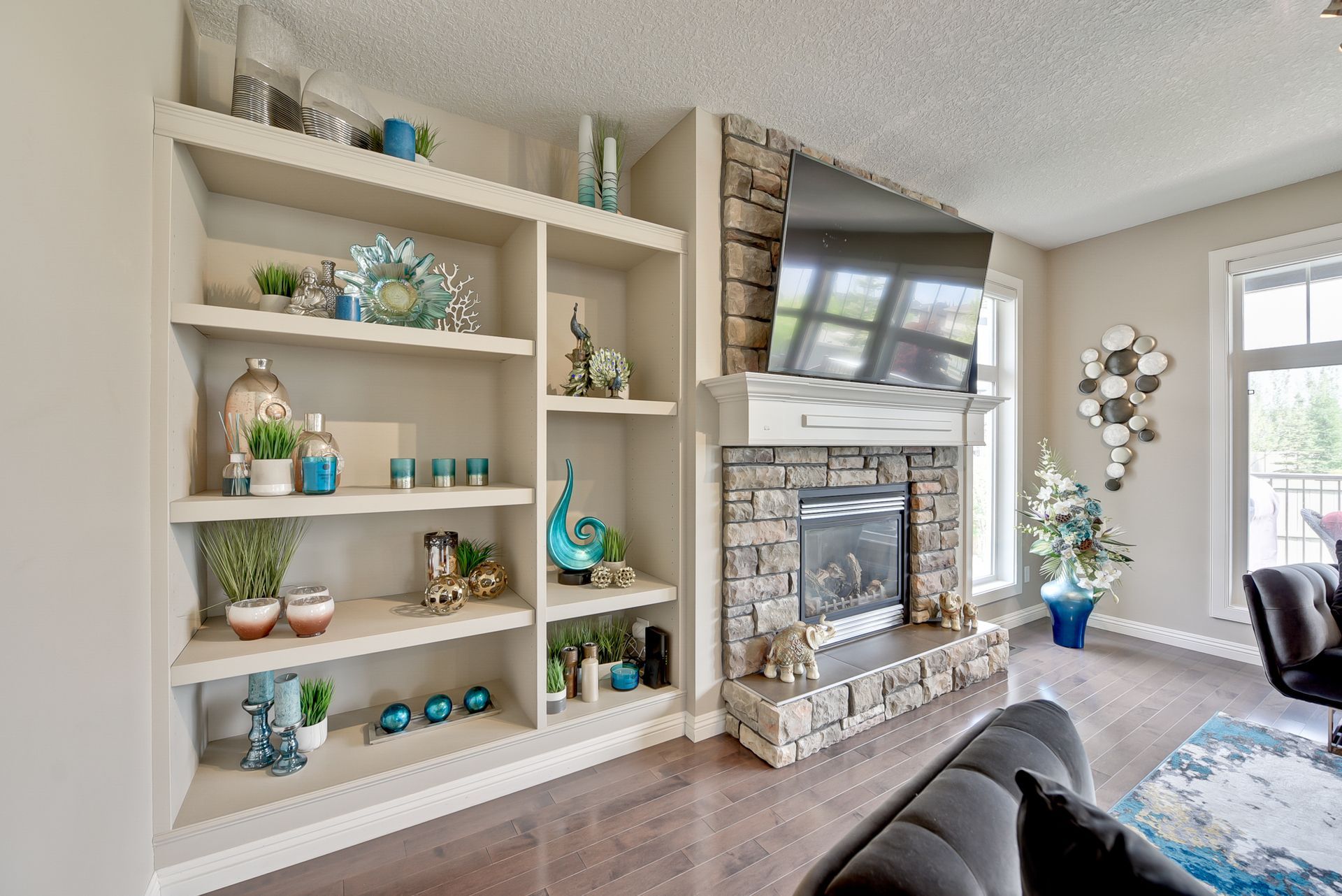 A living room with a fireplace and a flat screen tv.