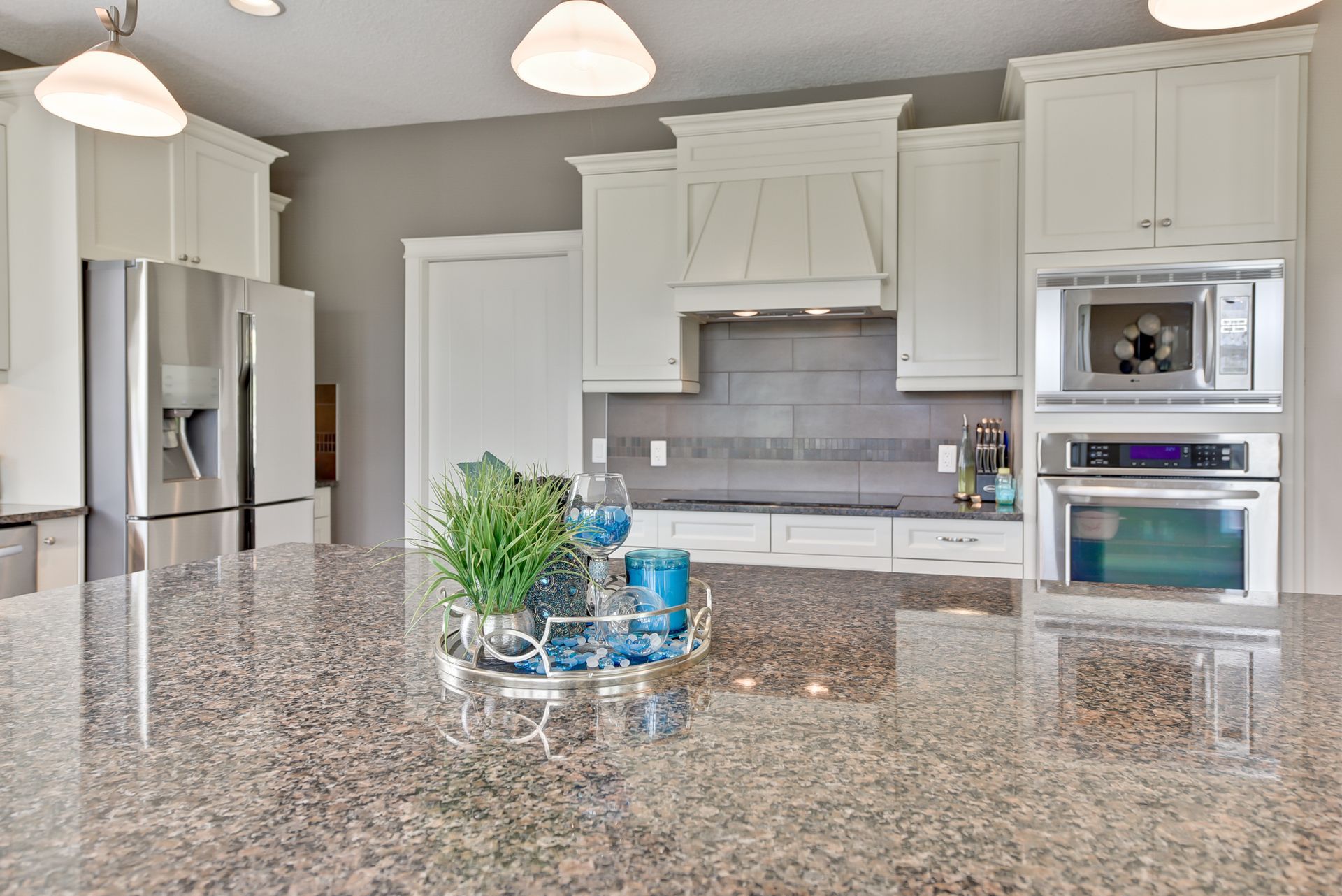 A kitchen with granite counter tops and stainless steel appliances
