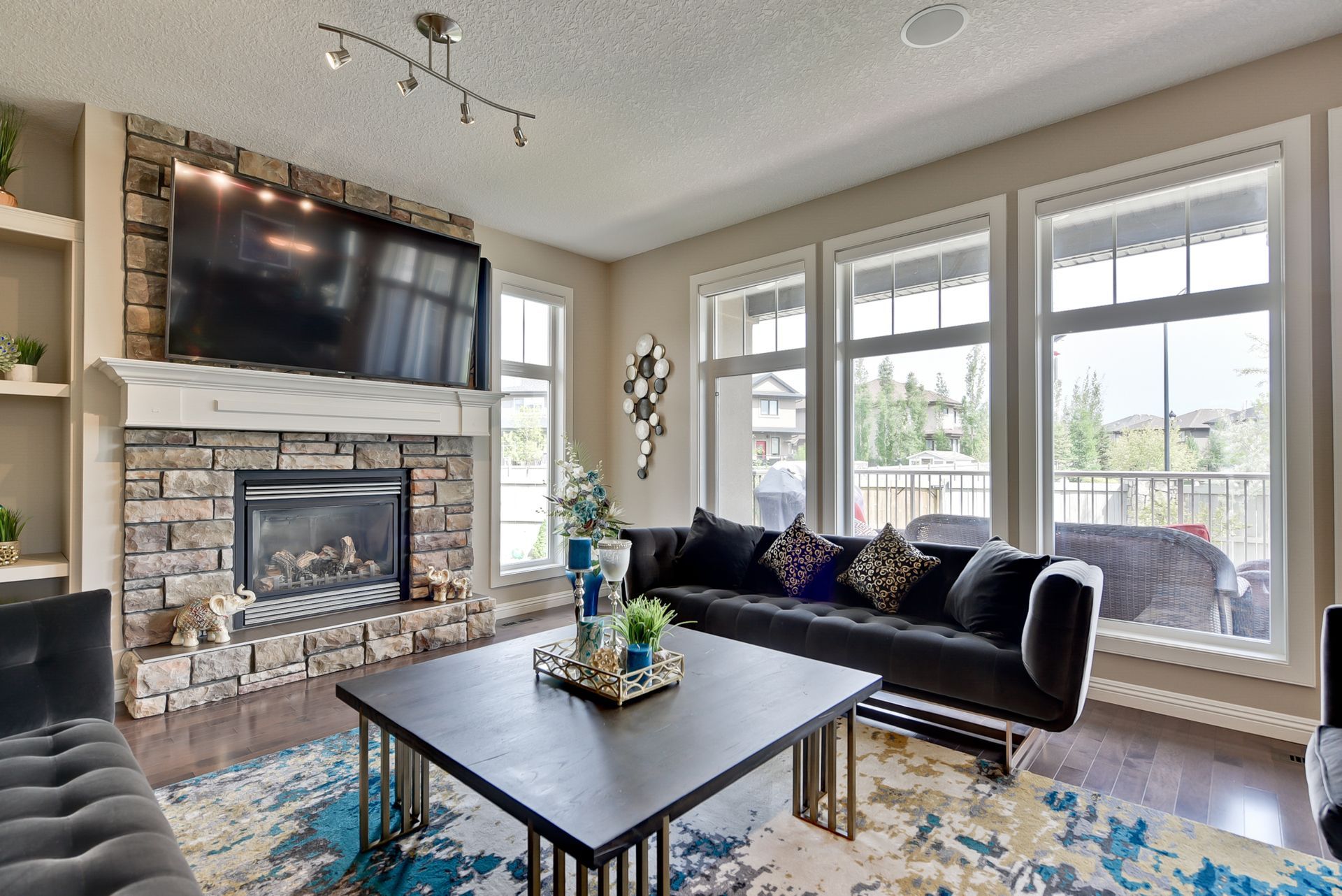A living room with a fireplace , couch , coffee table and television.