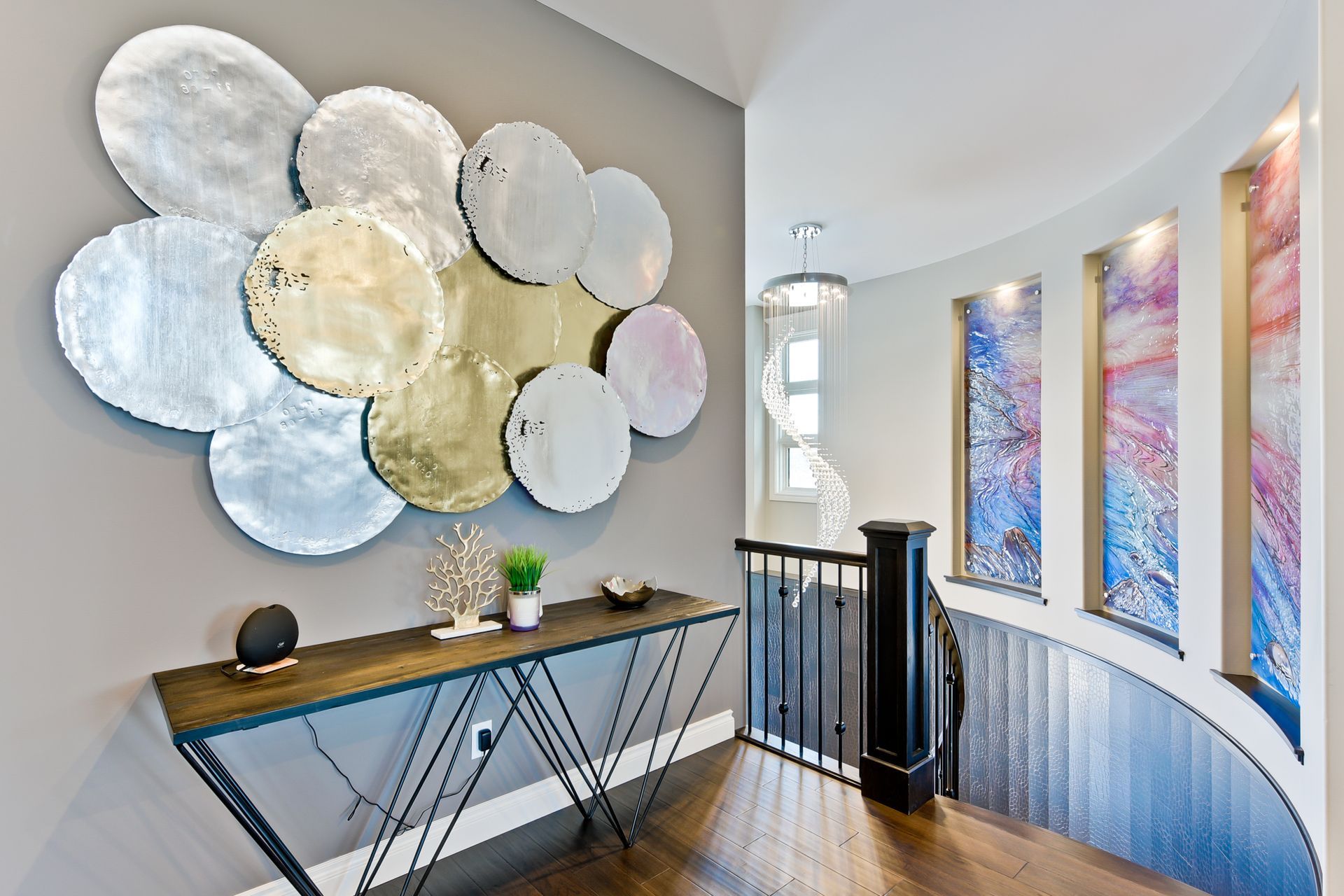 A hallway with a table and a painting on the wall.