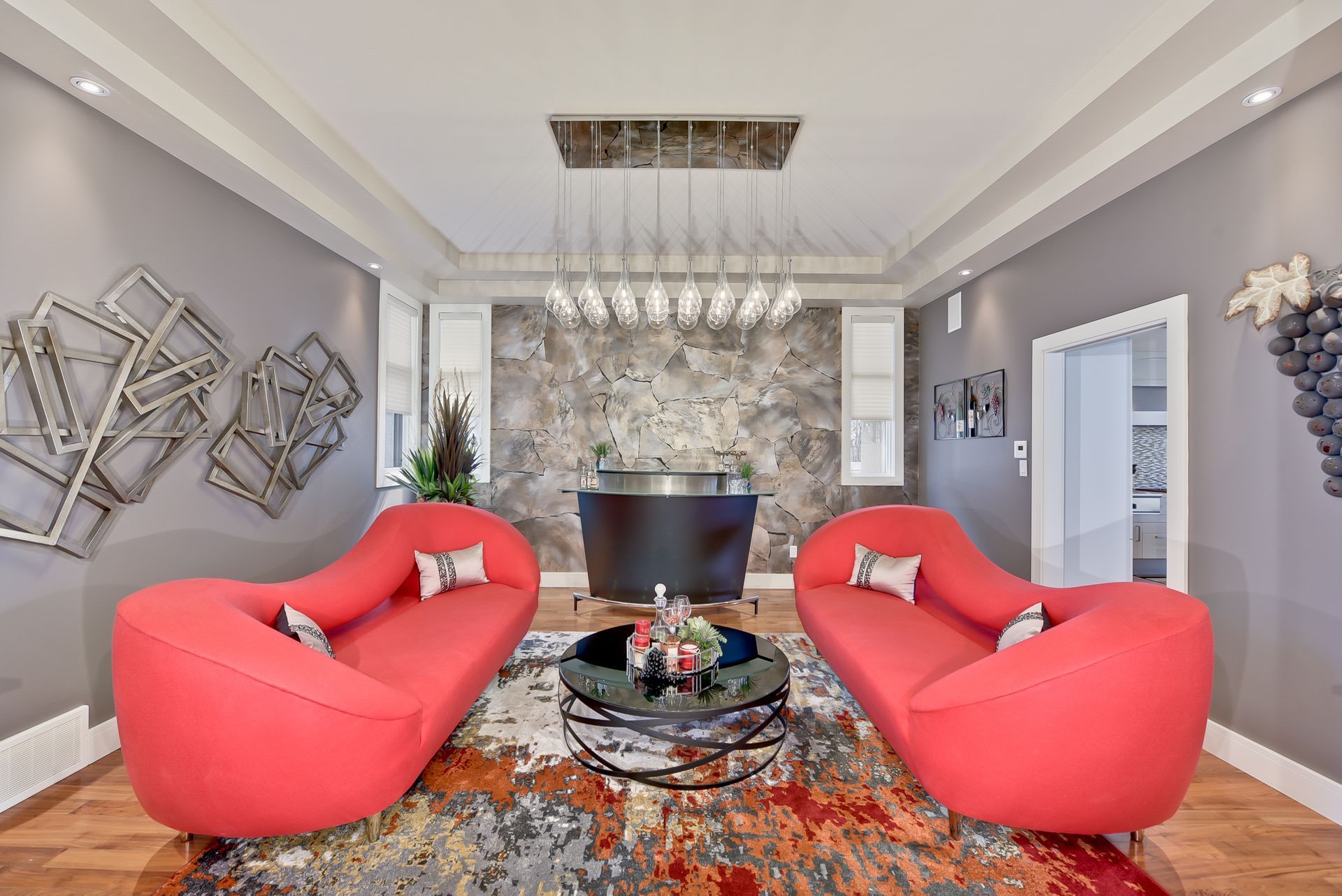 A living room with two red couches and a coffee table.