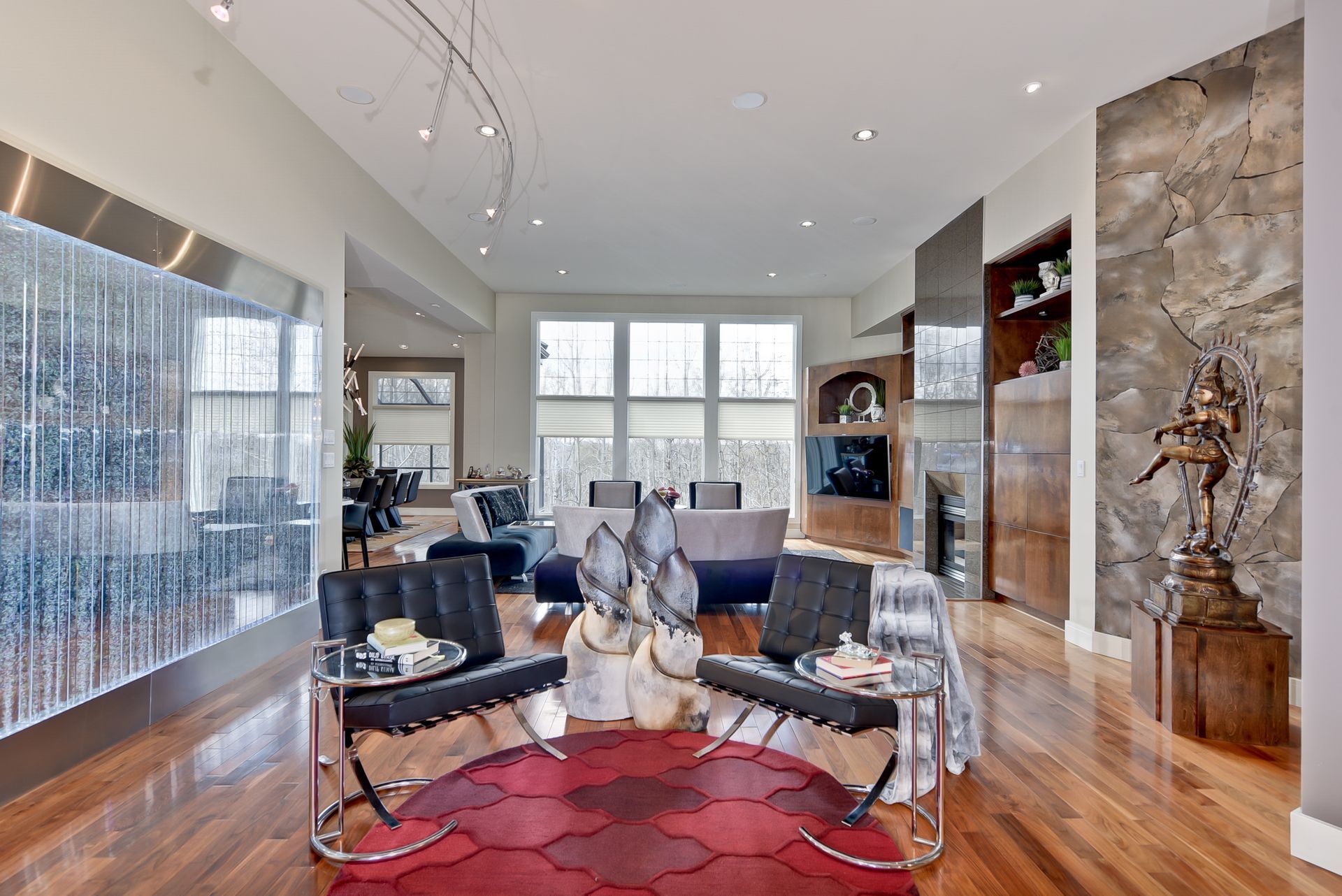 A living room with a red rug and two chairs
