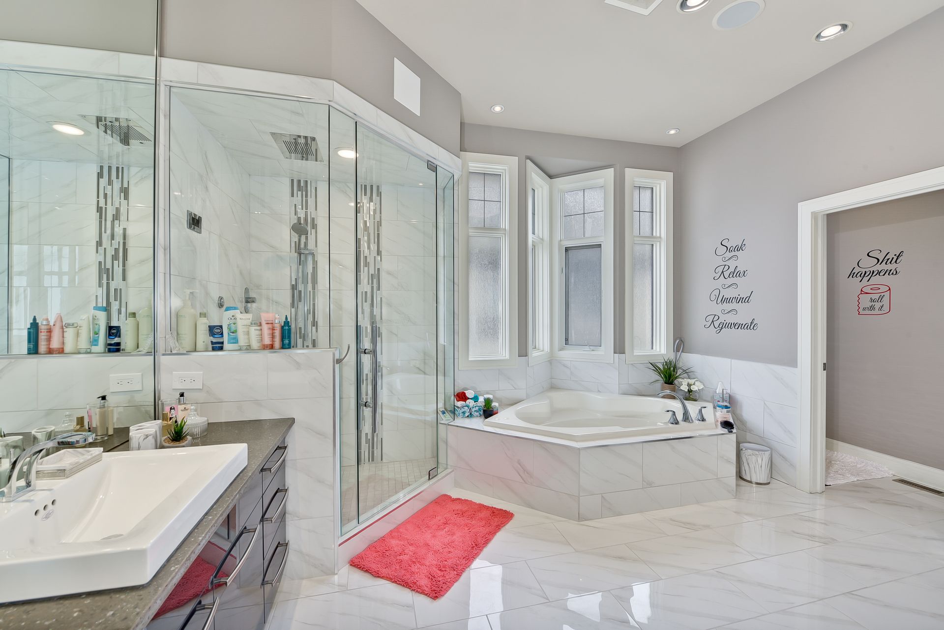 A bathroom with a tub , sink , and shower.