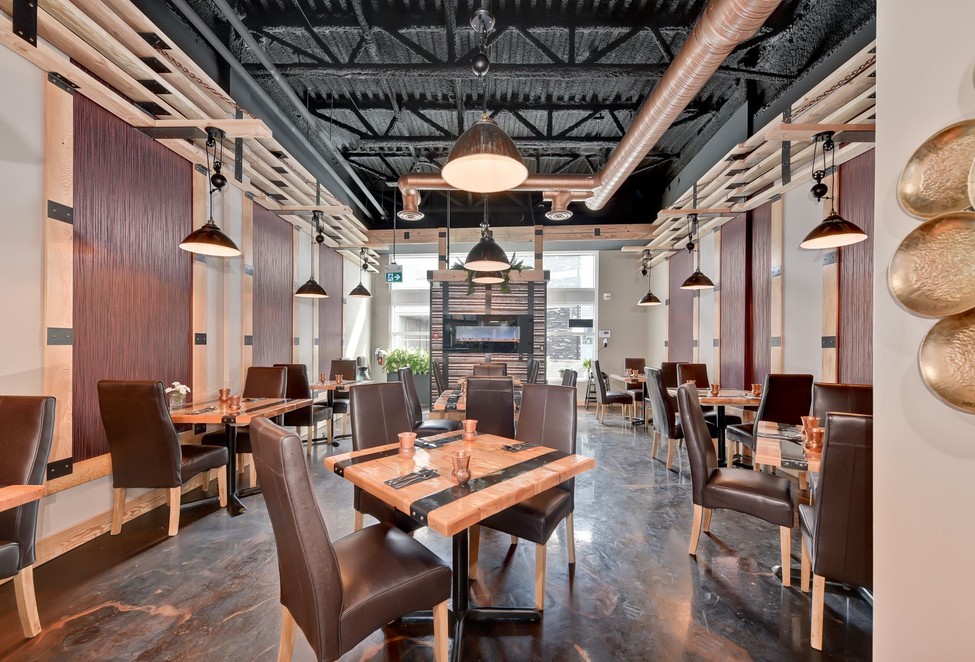 A large dining room with tables and chairs in a restaurant.