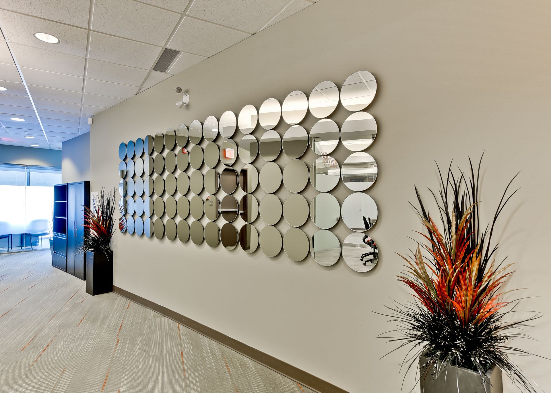 A hallway with a large mirror on the wall