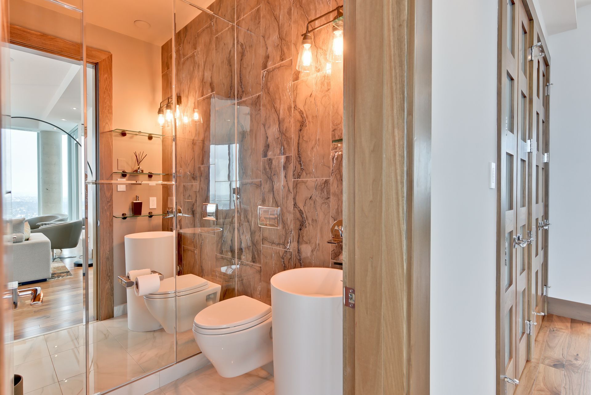 A bathroom with a toilet , sink and walk in shower.