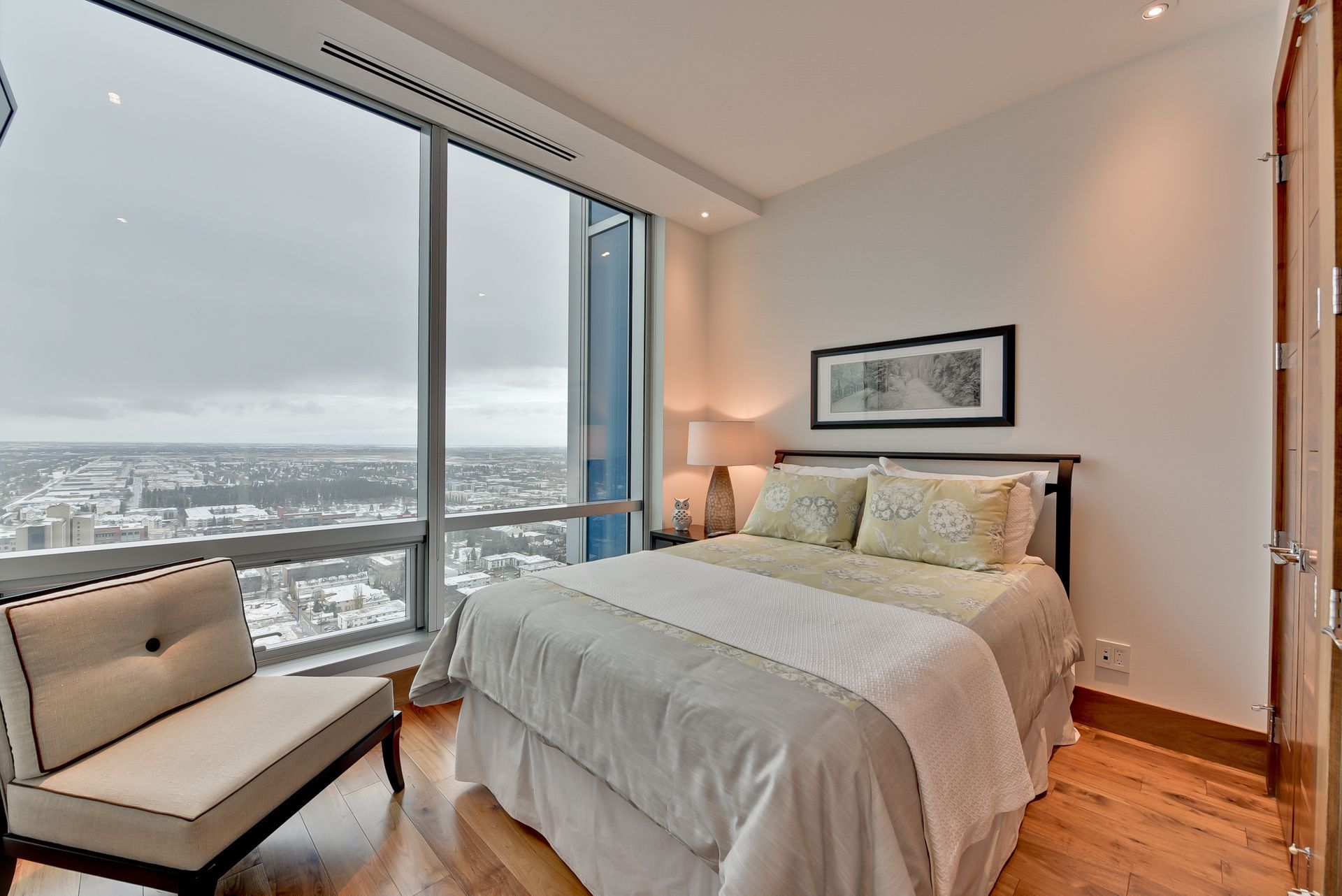 A bedroom with a large bed and a large window