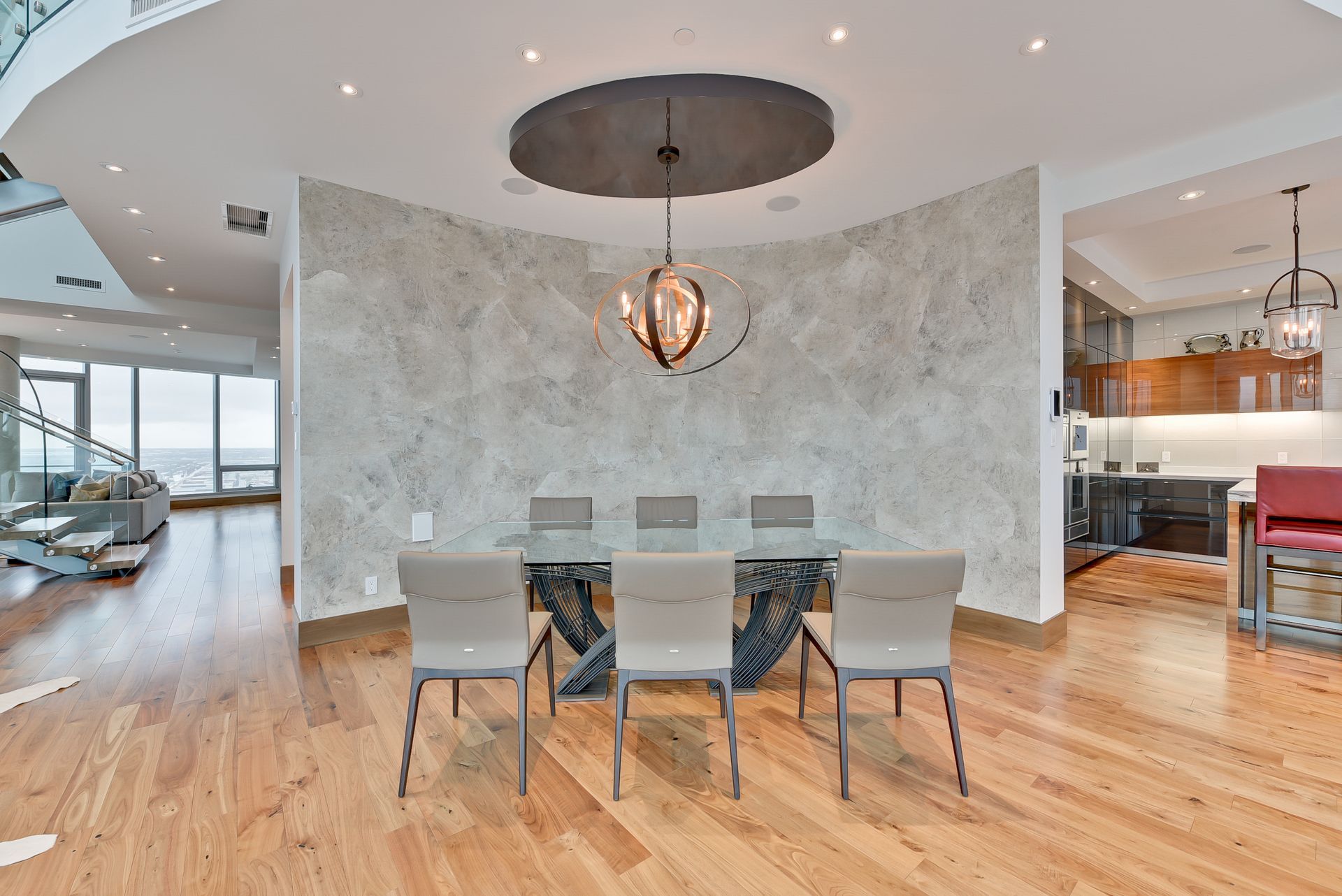 A dining room with a table and chairs and a chandelier hanging from the ceiling.