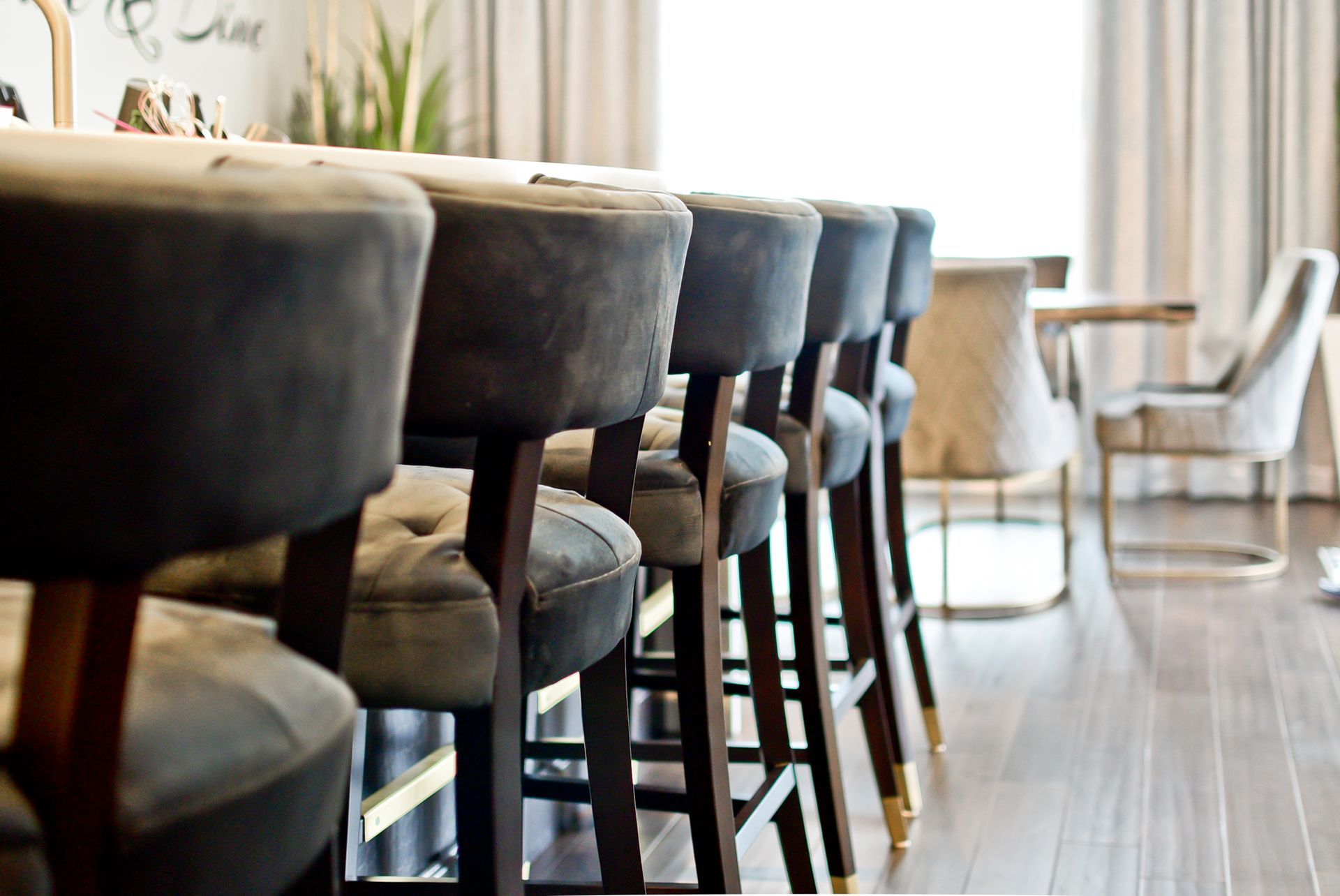 A row of bar stools are lined up in a room.