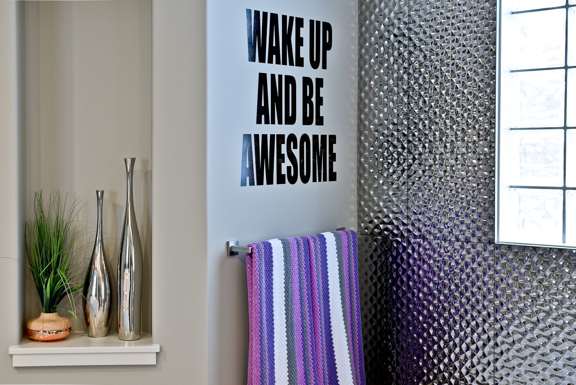 A bathroom with a sign that says wake up and be awesome