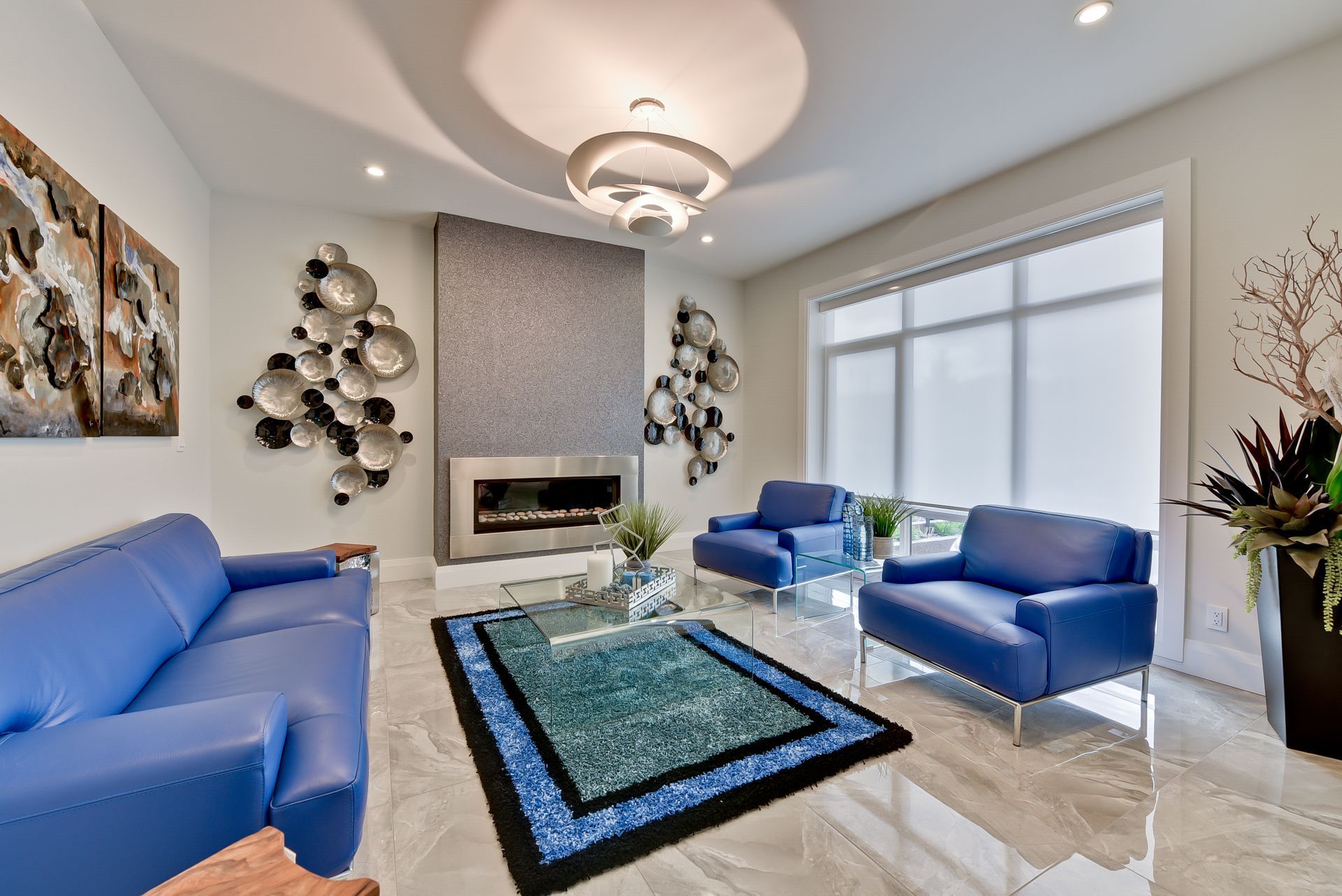 A living room with blue furniture and a fireplace