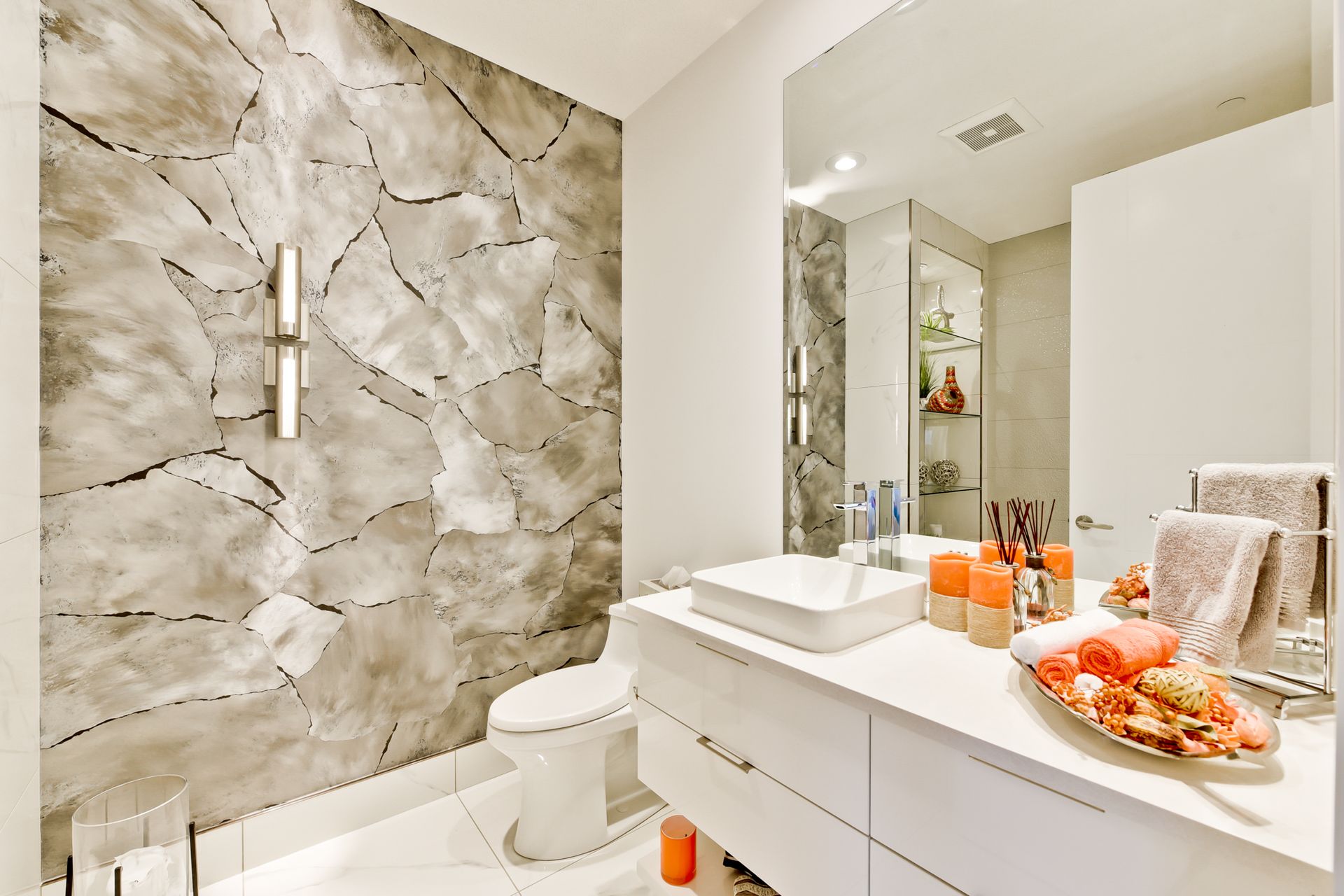 A bathroom with a sink , toilet , and mirror.