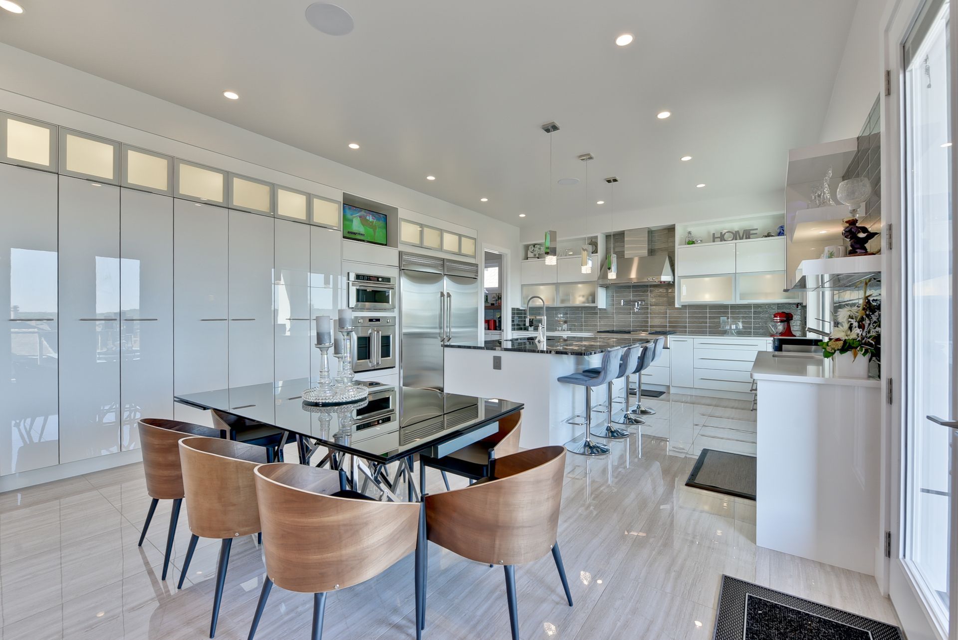 A kitchen with a table and chairs in it