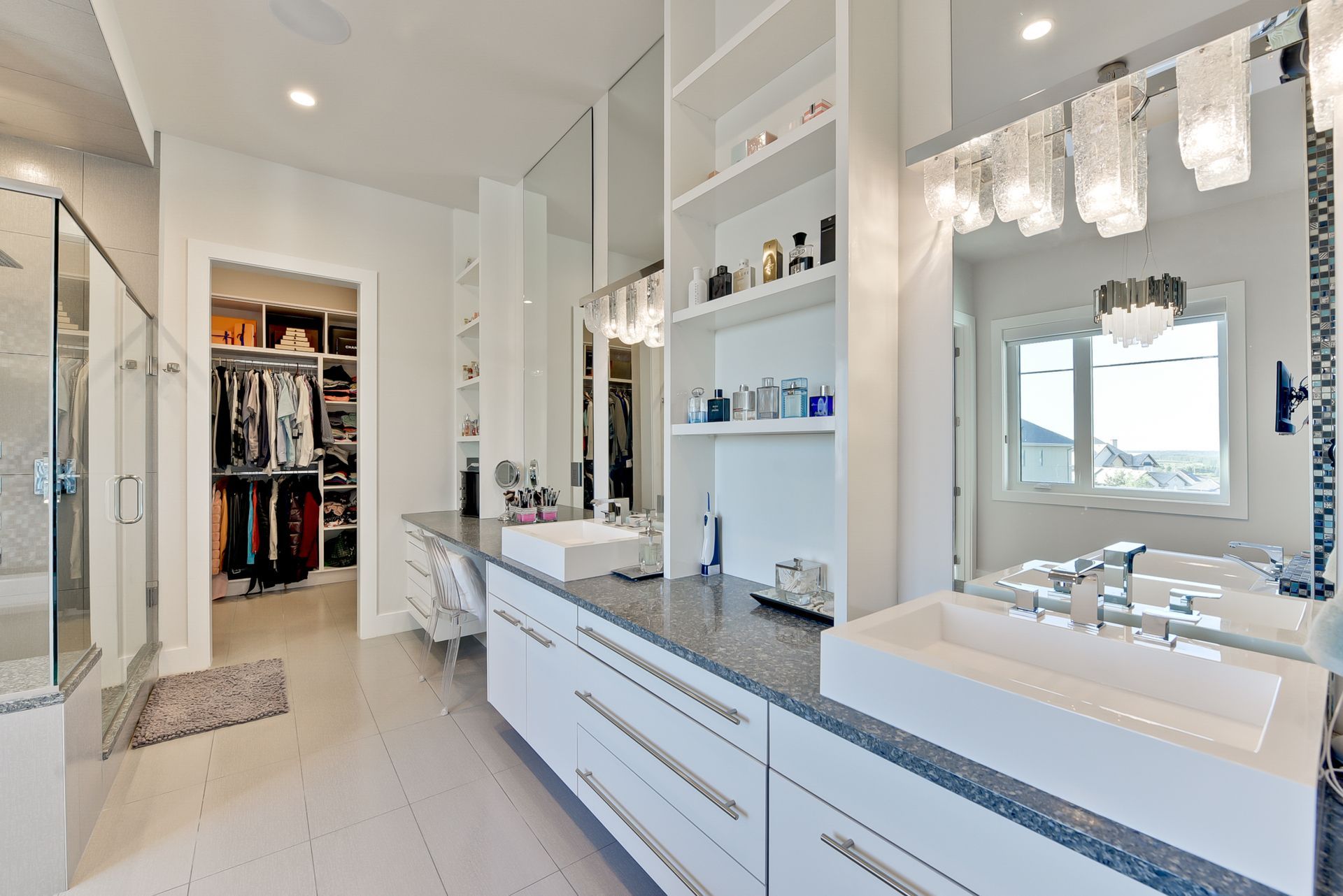 A bathroom with two sinks and a walk in closet