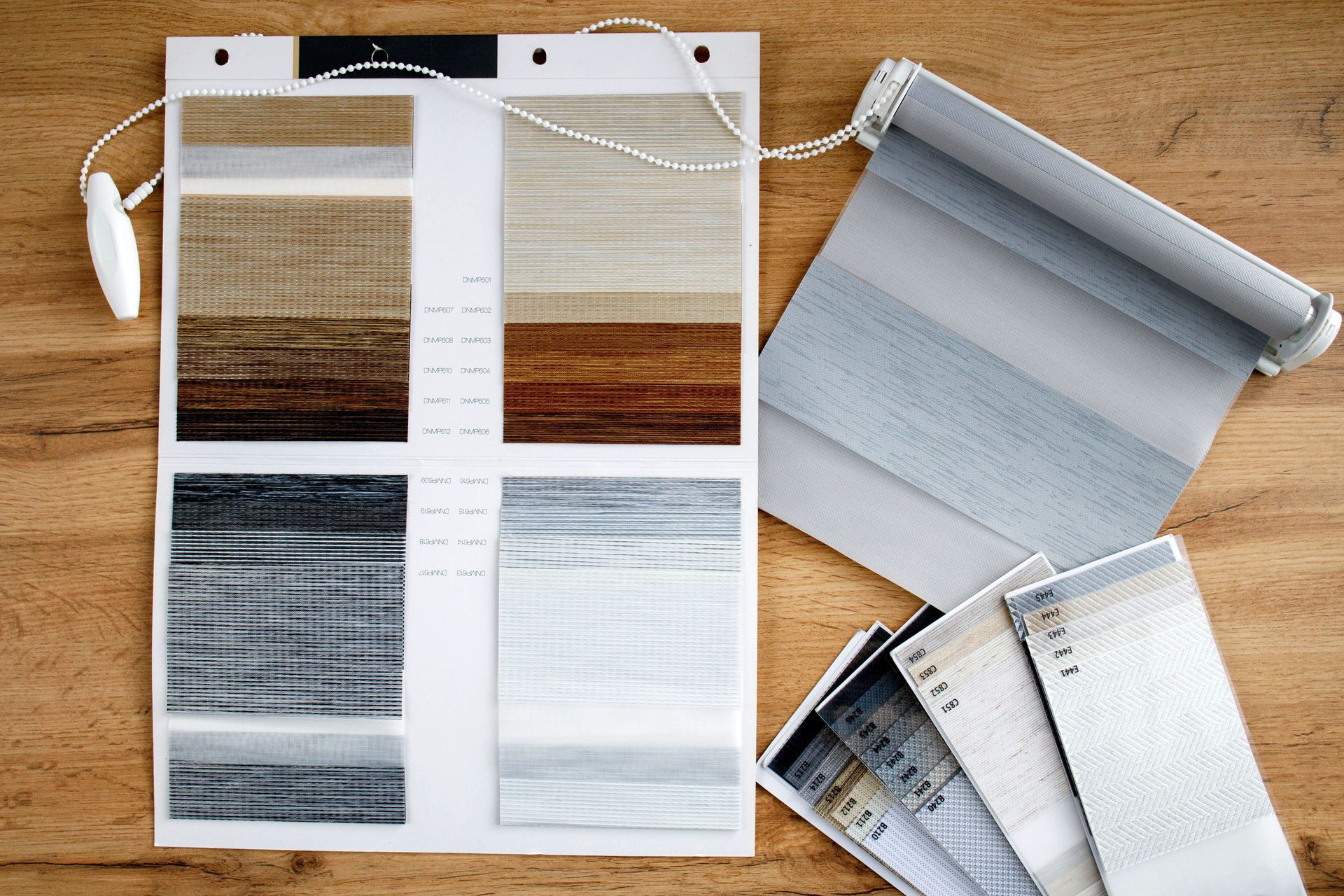 A wooden table with a bunch of different types of blinds on it