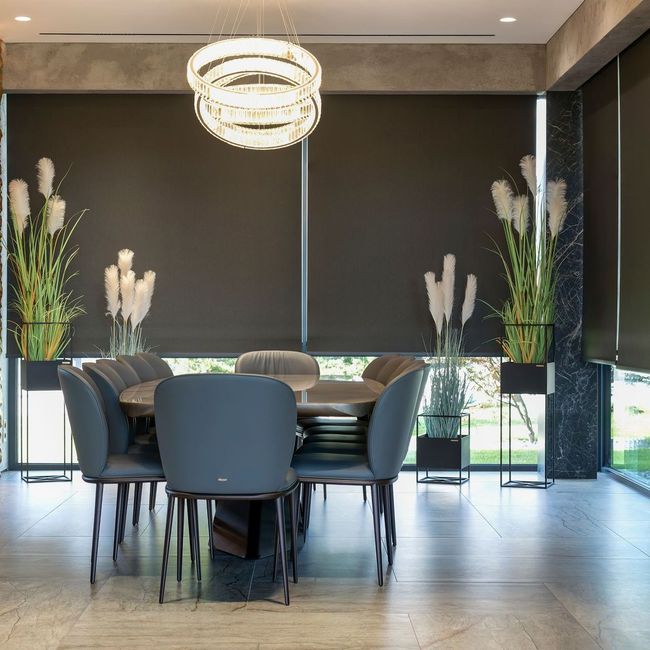 A dining room with a table and chairs and a chandelier.