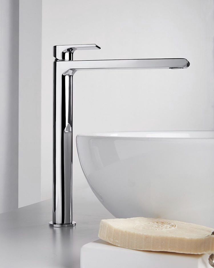 Un lavandino del bagno con un rubinetto cromato e una spugna