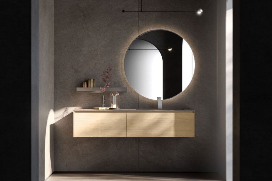 Un bagno con un lavandino e uno specchio rotondo