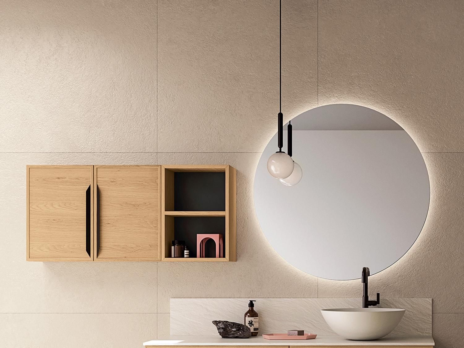 Un bagno con un lavandino e uno specchio rotondo