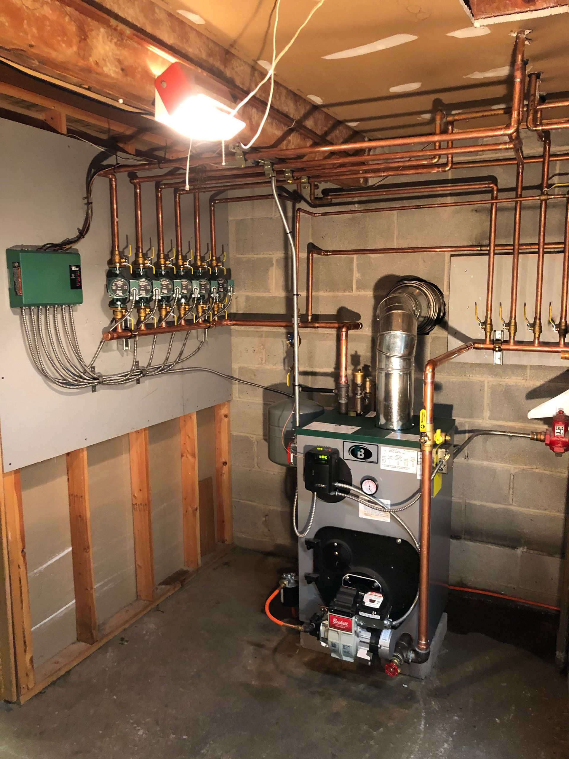 Air conditioning units with toolbox and gloves in backyard.