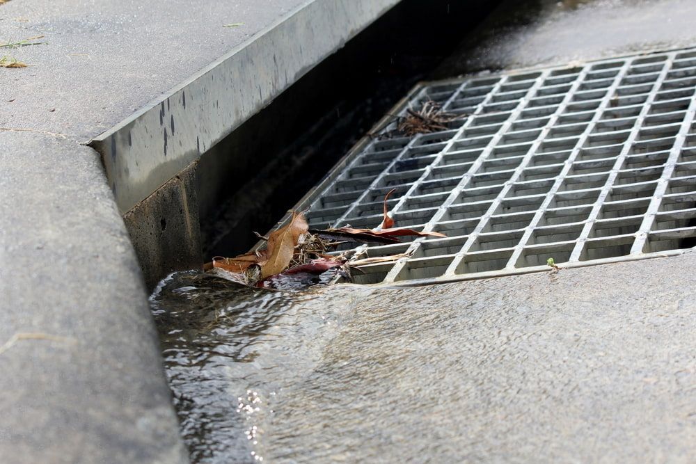 A Drain on the Side of a Road With Water Coming Out of It — Ausplumb NT in Winnellie, NT