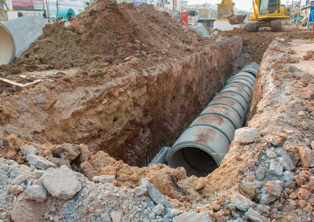 A Large Concrete Pipe is Being Installed in a Trench — Ausplumb NT in Winnellie, NT