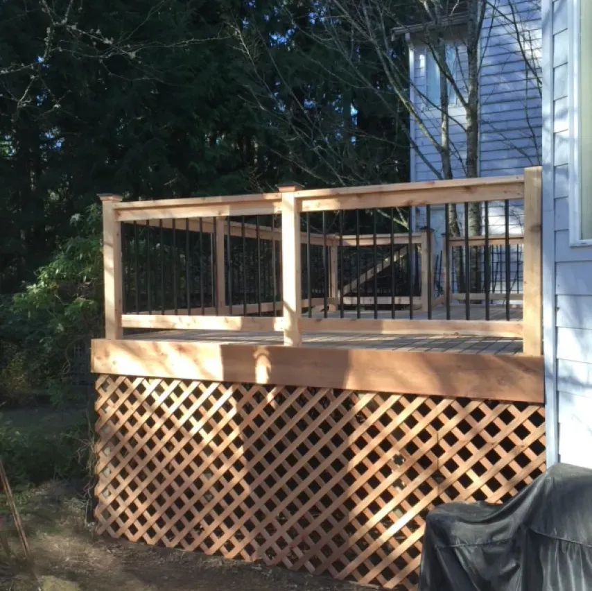 A wooden deck with a lattice fence around it