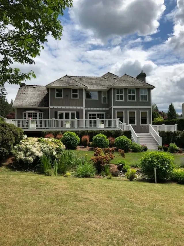 A large house with a large lawn in front of it.