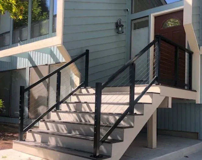 A set of stairs leading up to the front door of a house