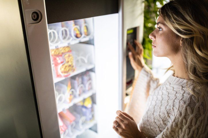 Woman putting her order in at a vending machine