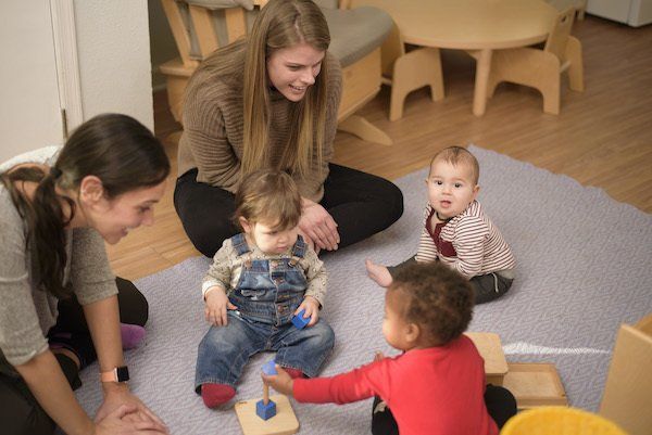Guides and children in a Montessori classroom